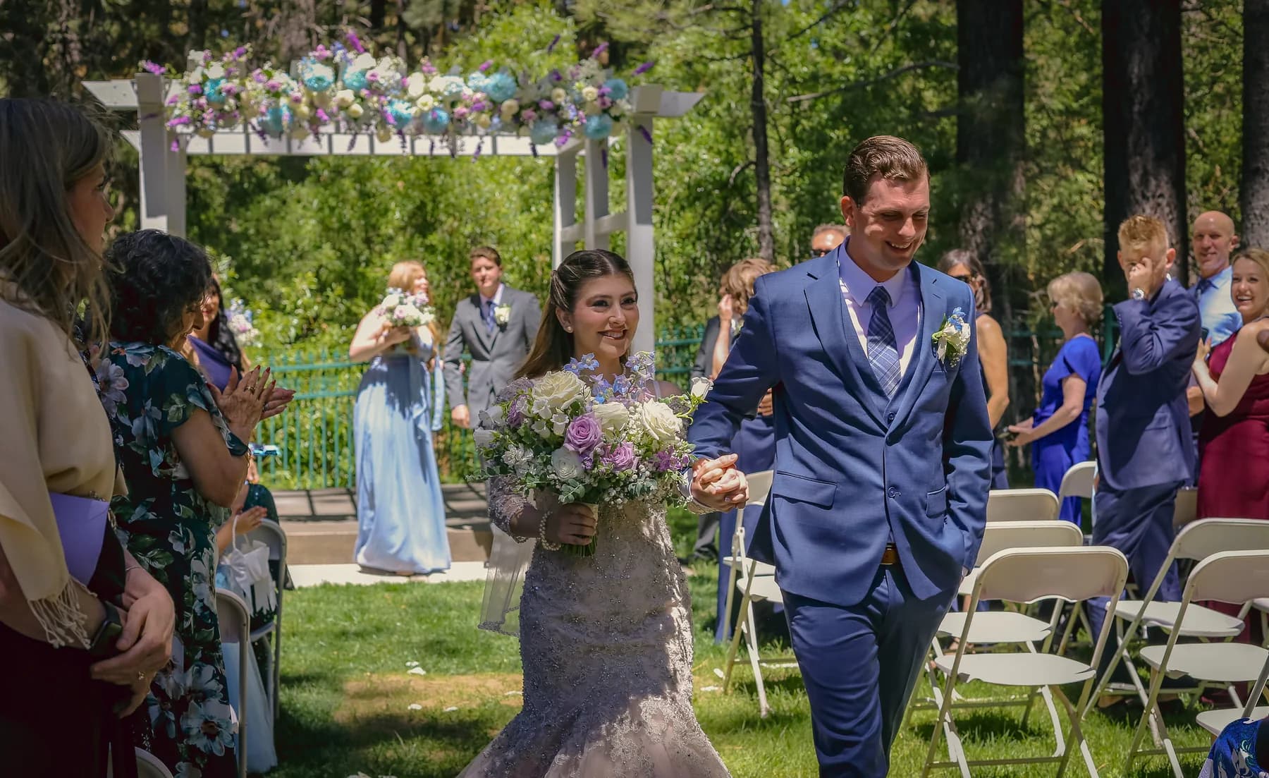 Gloria and Ryan walking between guests after their outdoor ceremony