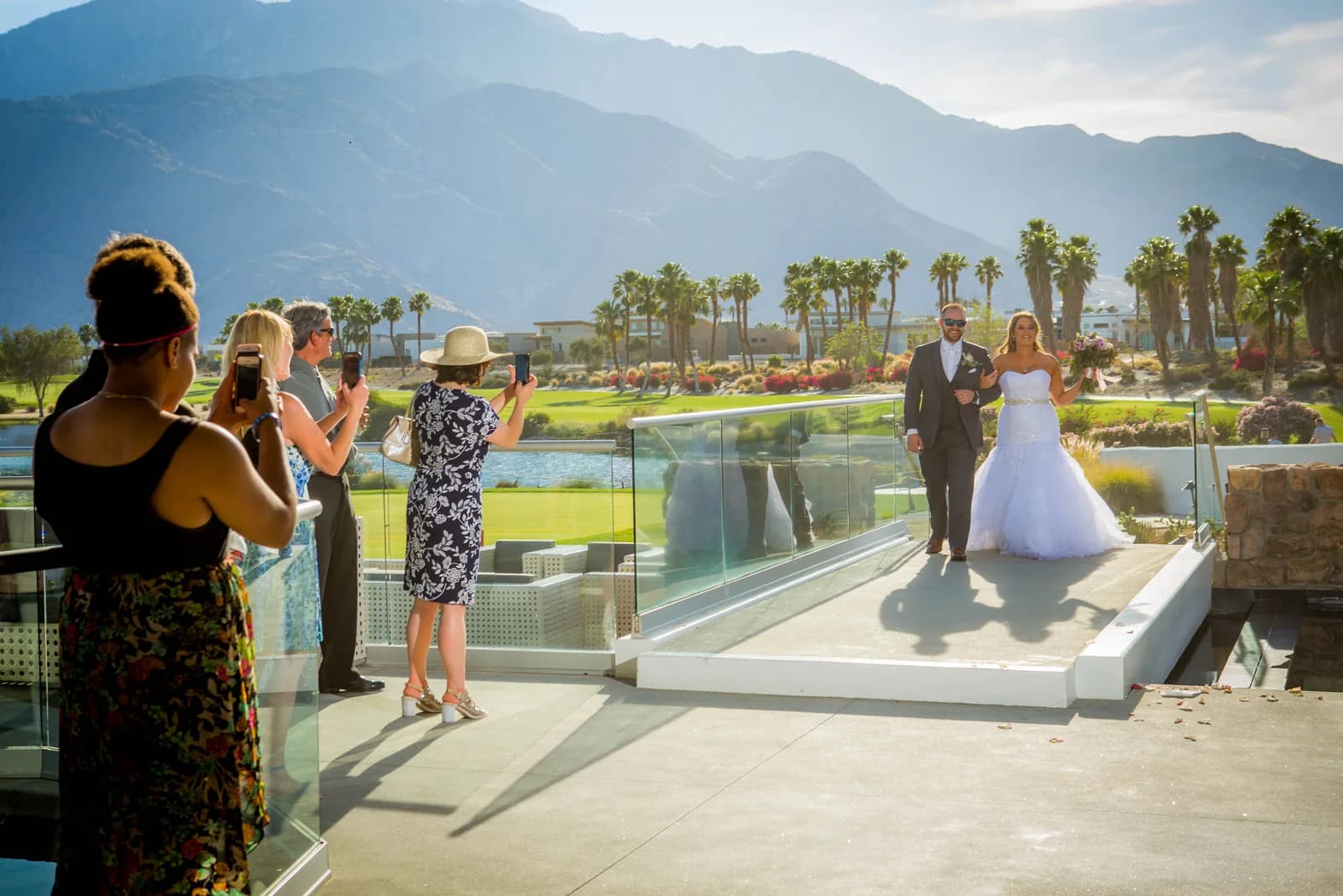 Stephen and Heather entering a terrace with the sunlit San Jacinto Mountains behind them