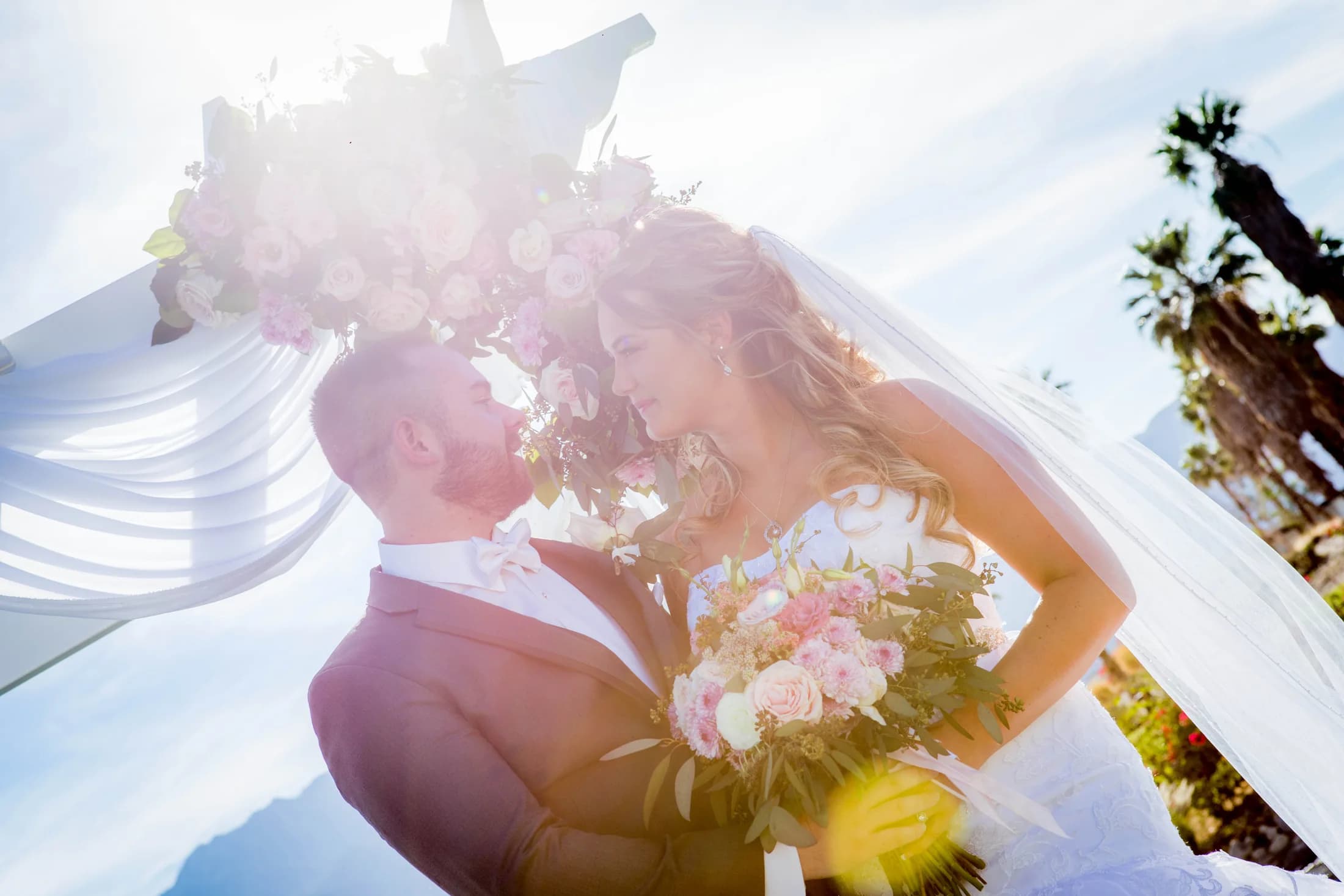 Stephen and Heather sharing a sunlit portrait with the San Jacinto Mountains behind them