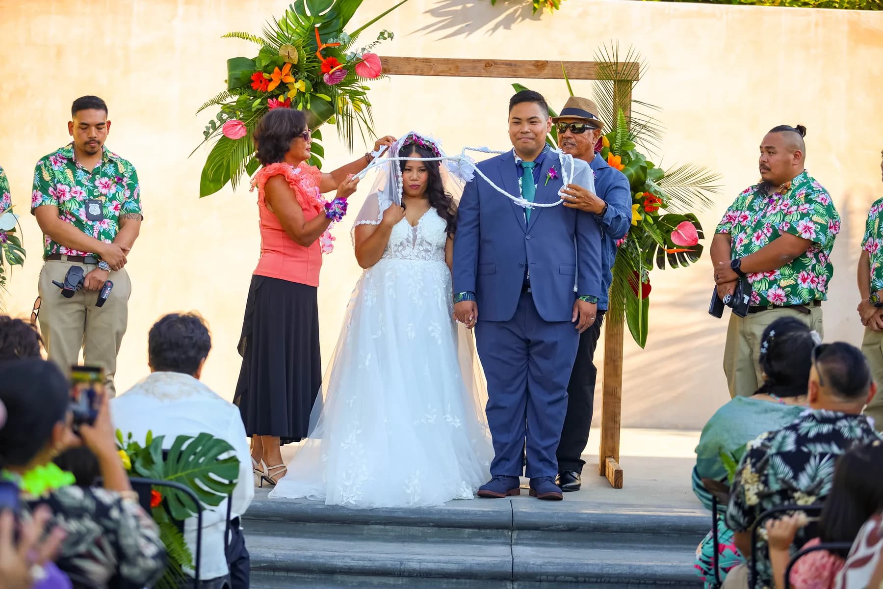 A guest placing a lei over Azalea during the ceremony