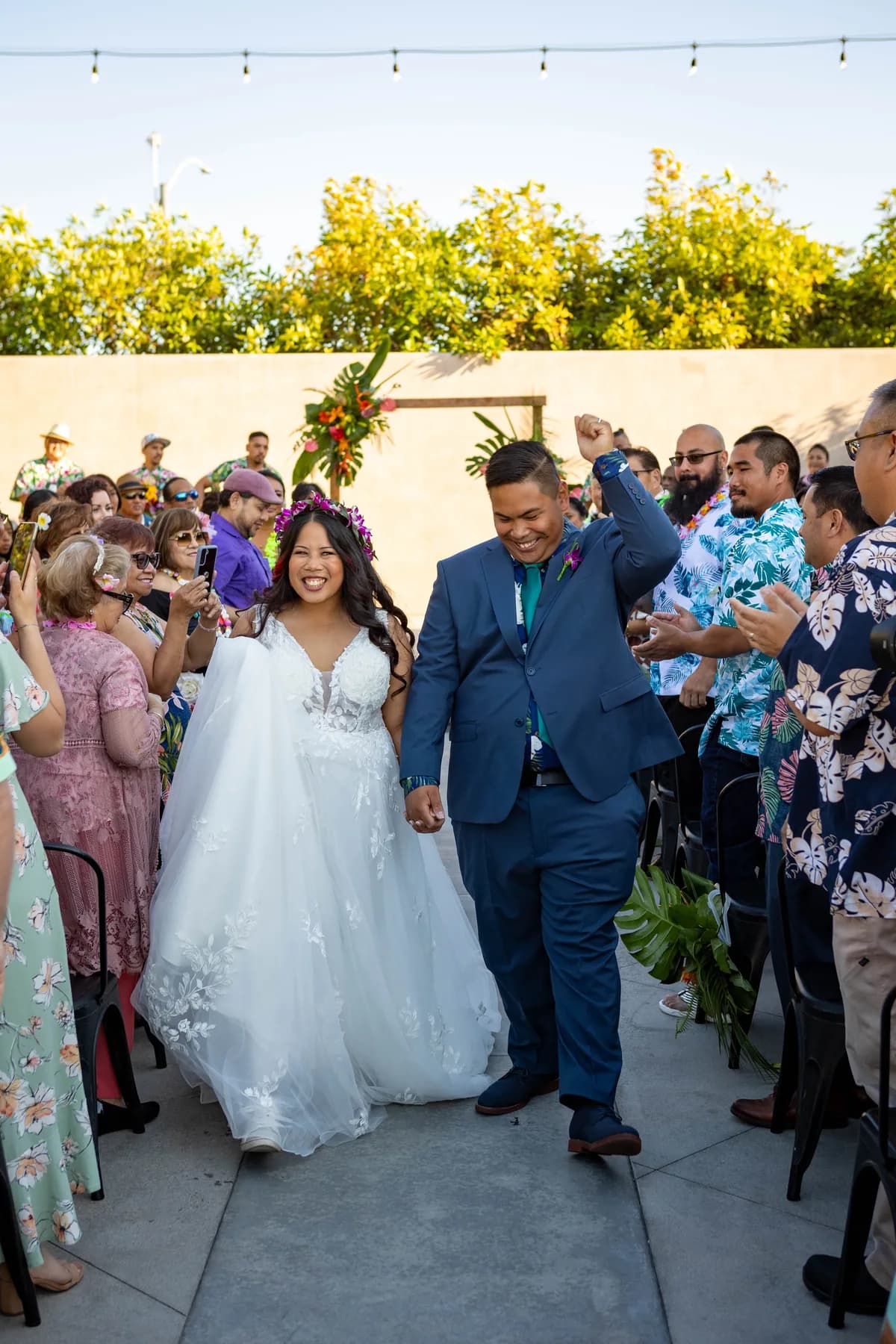 Jed and Azalea walking down the outdoor aisle together