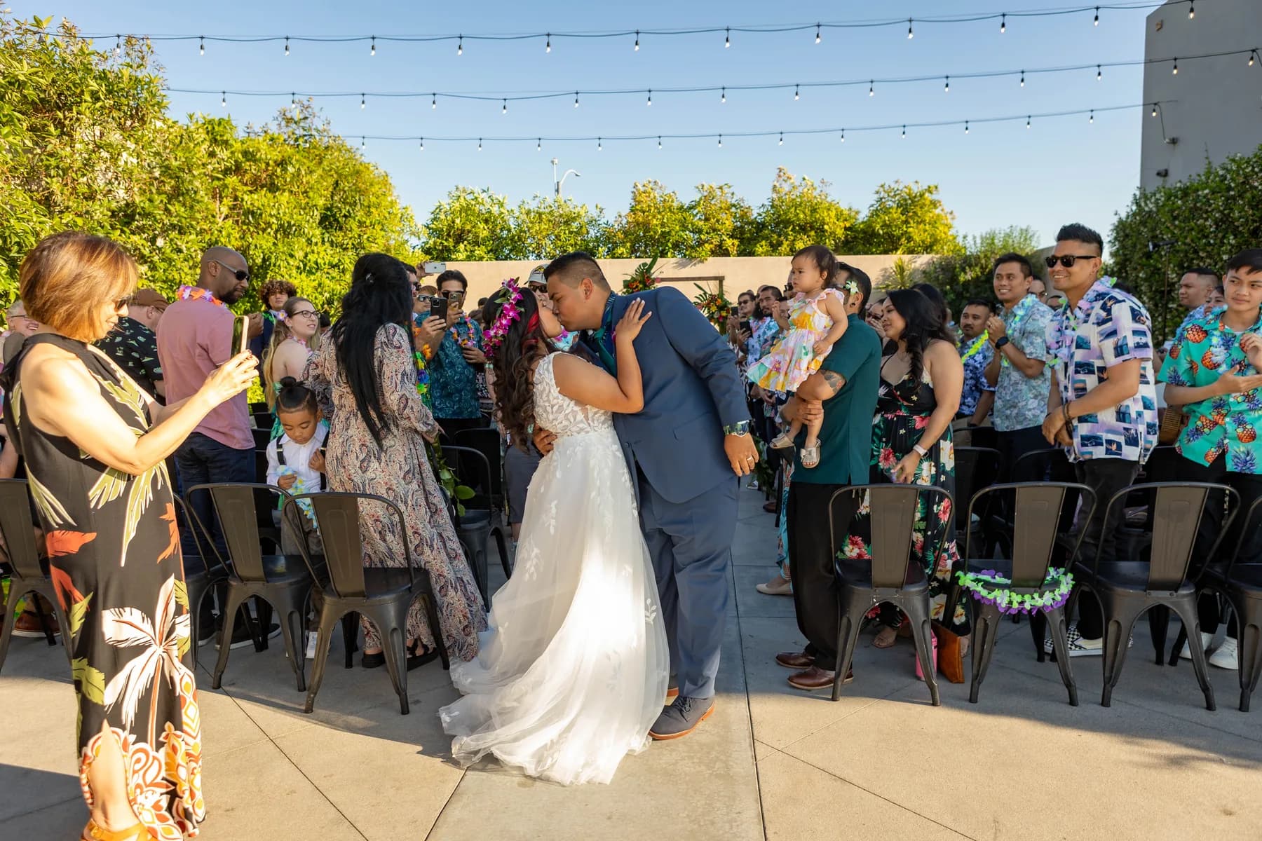 Jed and Azalea kissing as guests watch outdoors