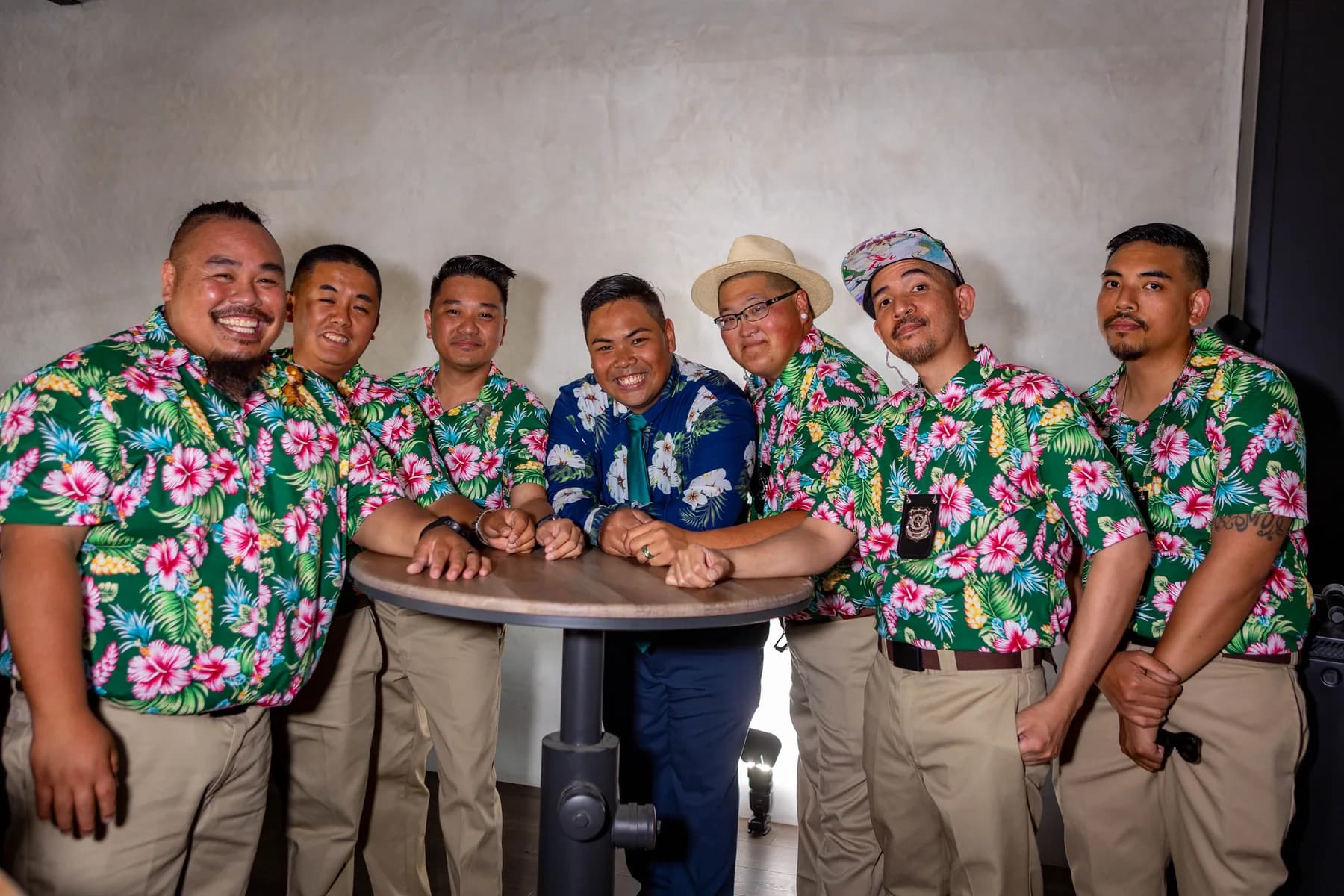 Jed with attendants wearing colorful floral shirts