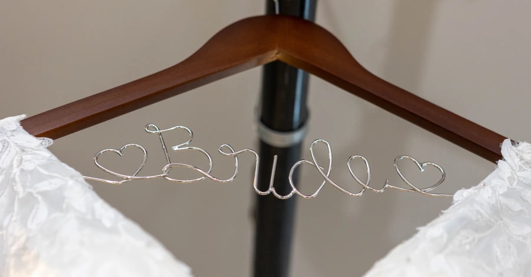 Azalea’s wedding dress hanging on a personalized wooden hanger