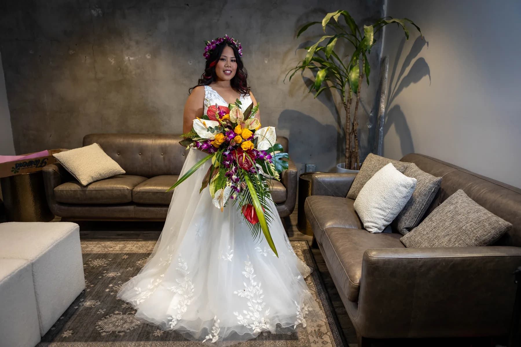 Azalea holding a tropical bouquet in the Hangar 21 South preparation room
