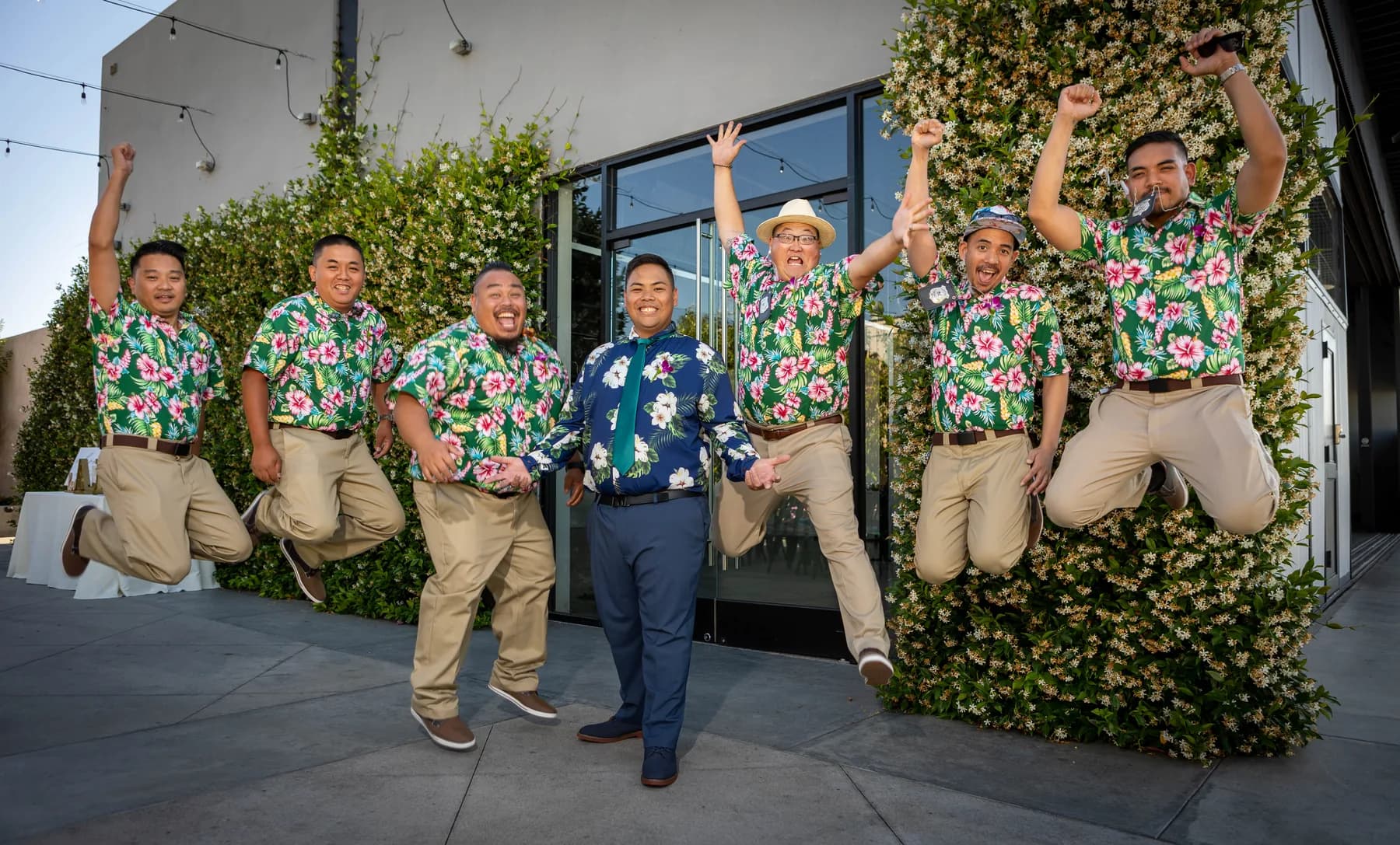 Jed and attendants jumping for a playful group portrait