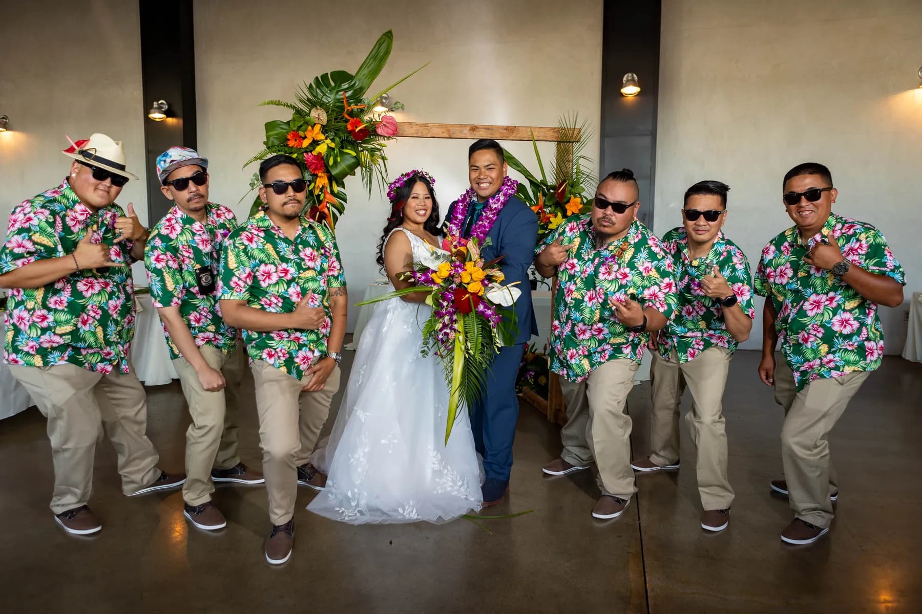 Wedding-party portrait with Jed and Azalea beneath the floral arch