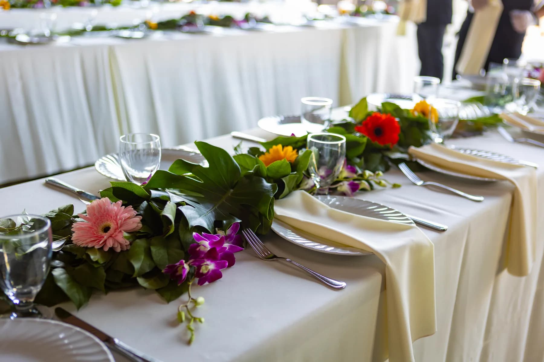 Reception table set with tropical flowers and white linens