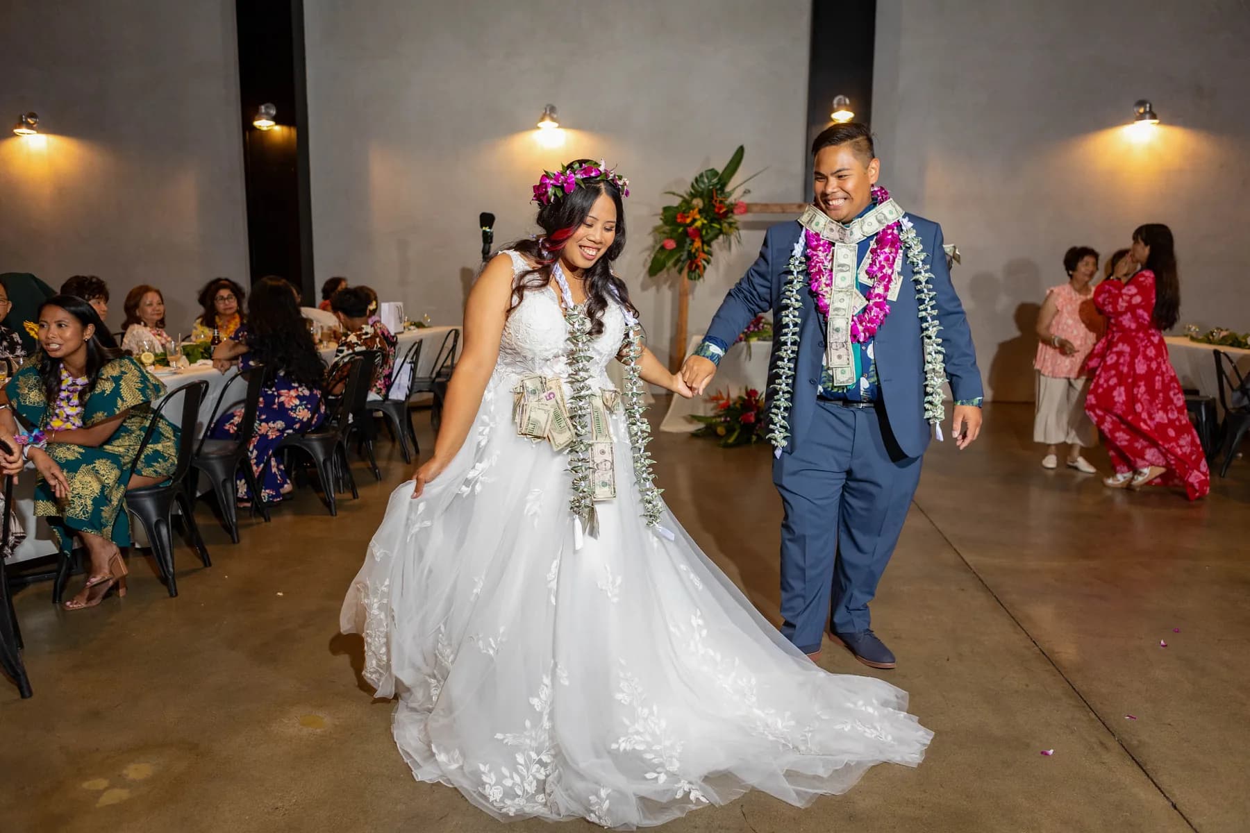 Jed and Azalea walking together across the reception floor