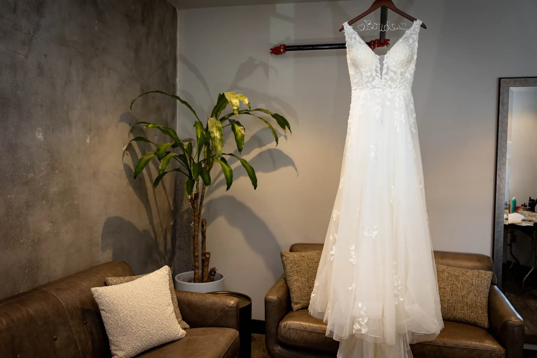 Wedding dress hanging in the preparation room at Hangar 21 South