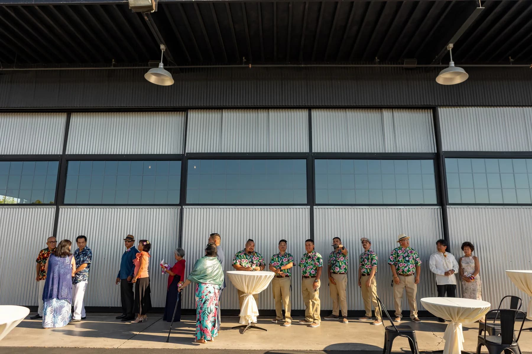 Guests gathered beside the wide hangar doors at Hangar 21 South