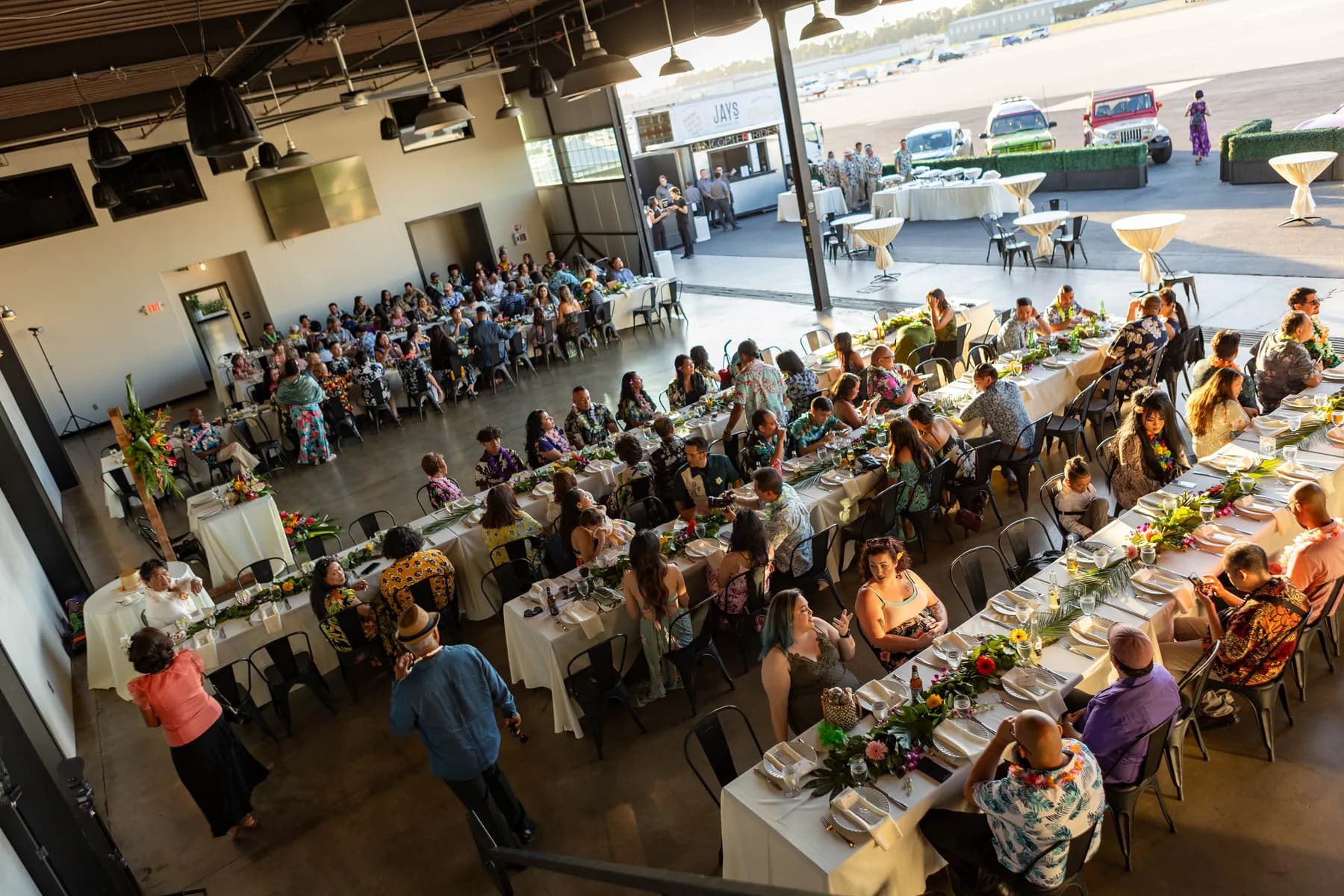 Wedding guests seated in the open Hangar 21 South reception space