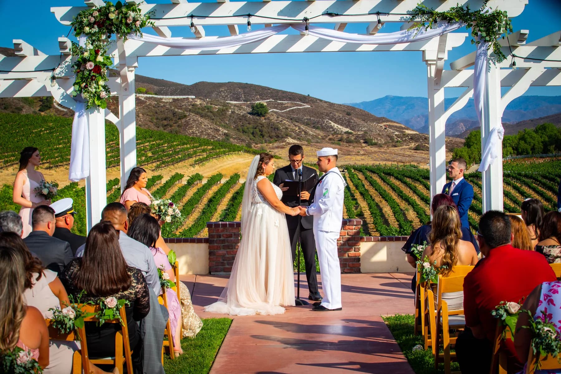 Deidriana and Gustavo standing beneath the ceremony pergola