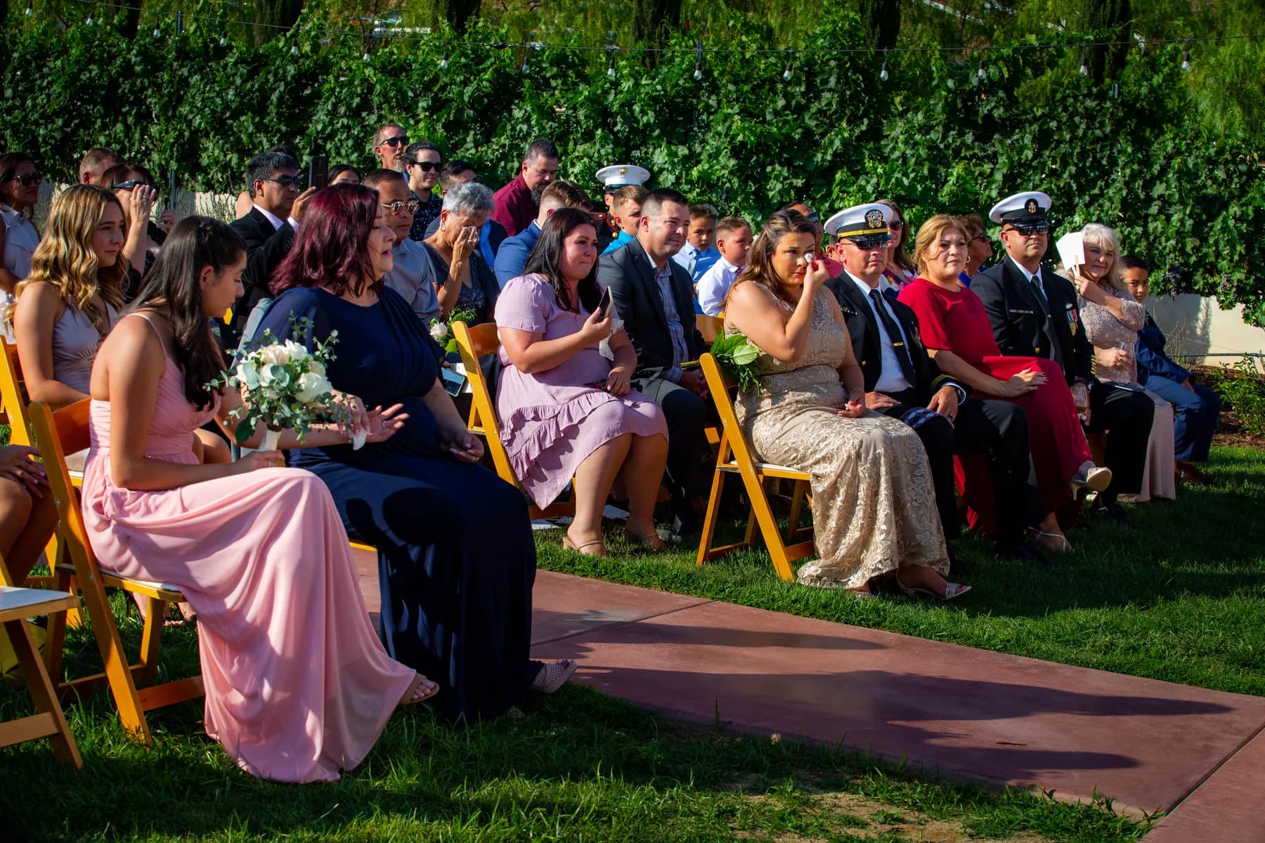 Guests watching the outdoor vineyard ceremony