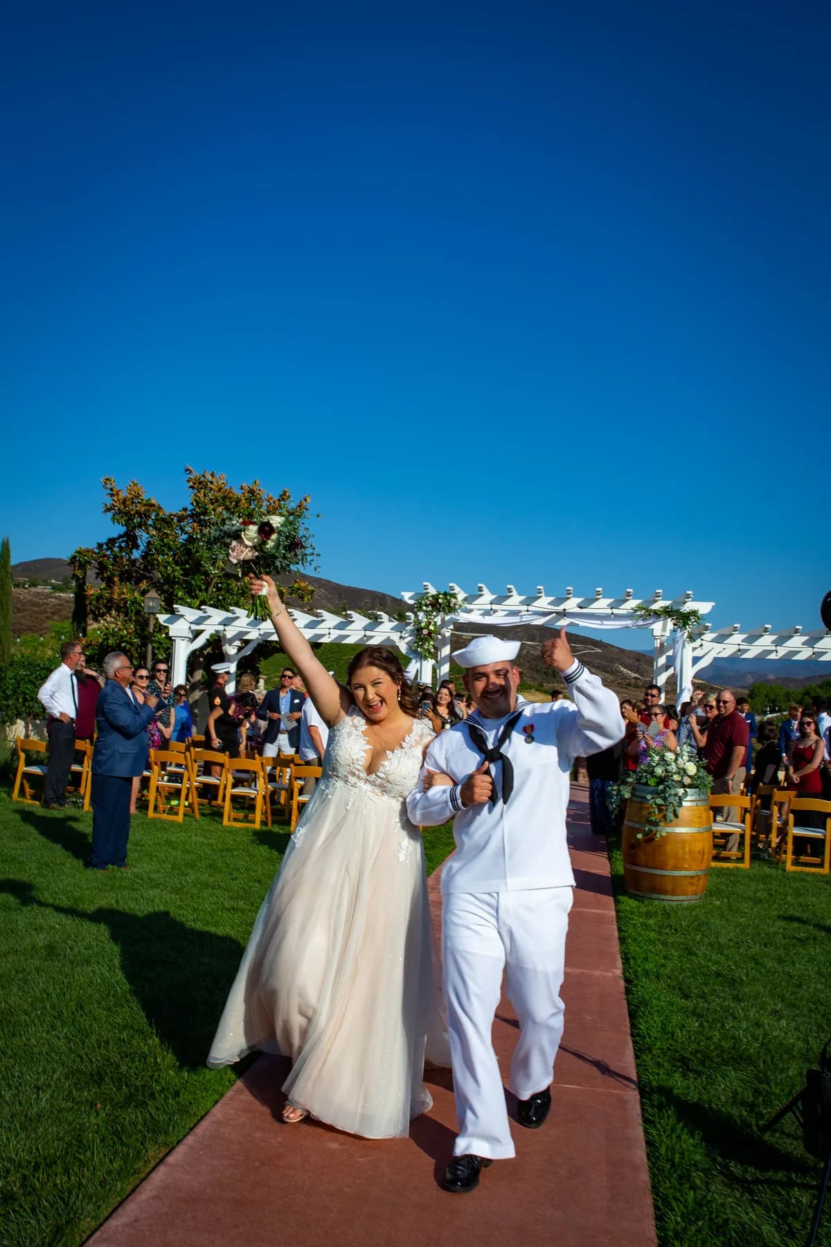 Deidriana and Gustavo celebrating during their ceremony recessional