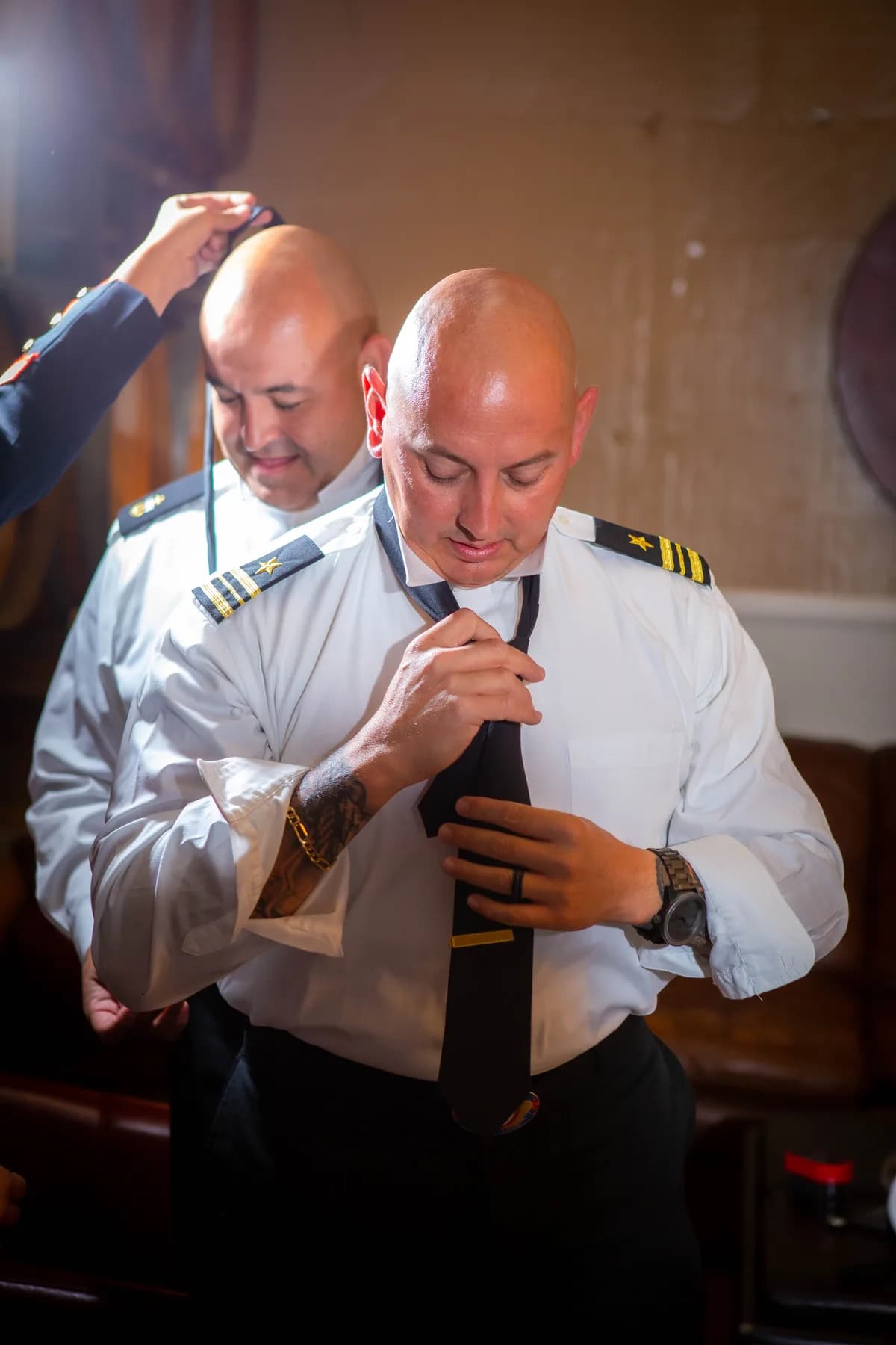Gustavo making final adjustments to his white dress uniform