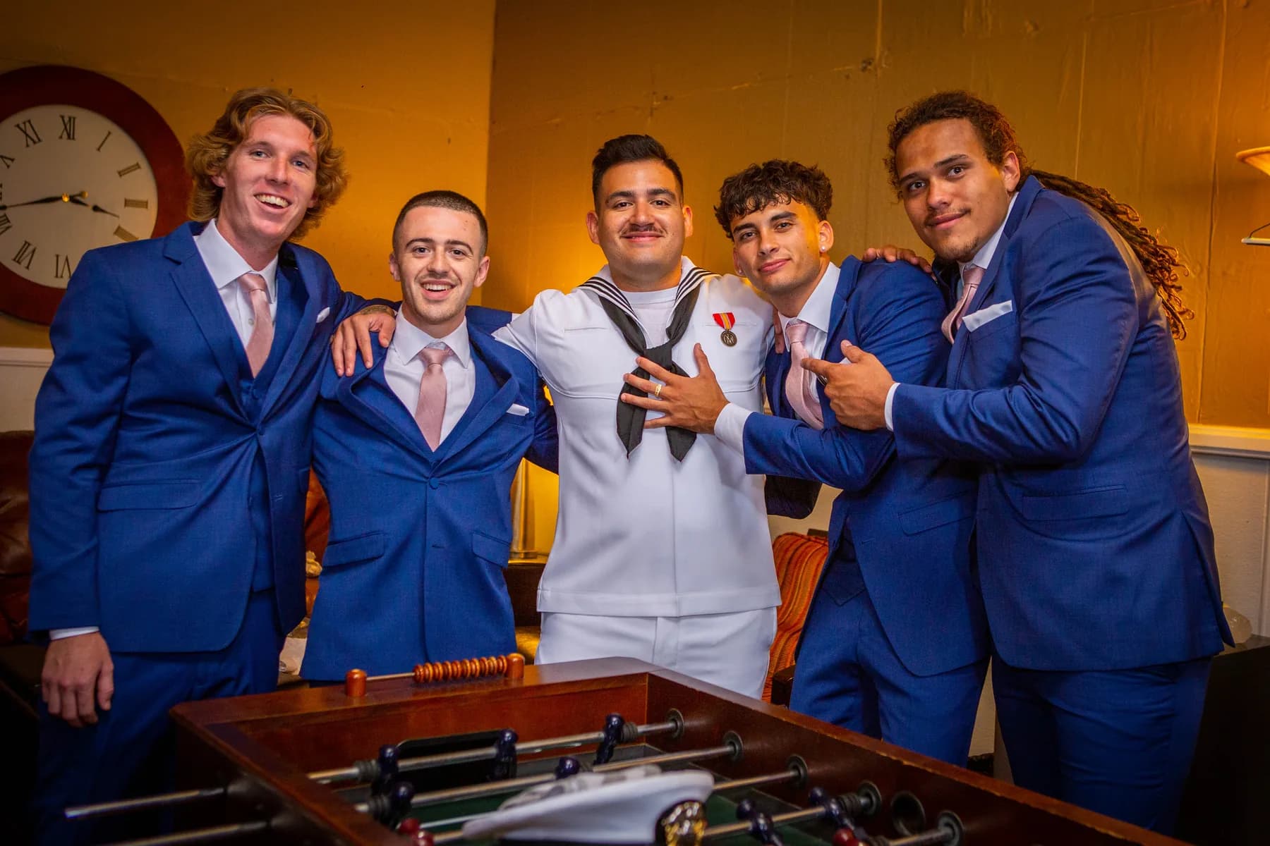 Gustavo and attendants gathered around a pool table