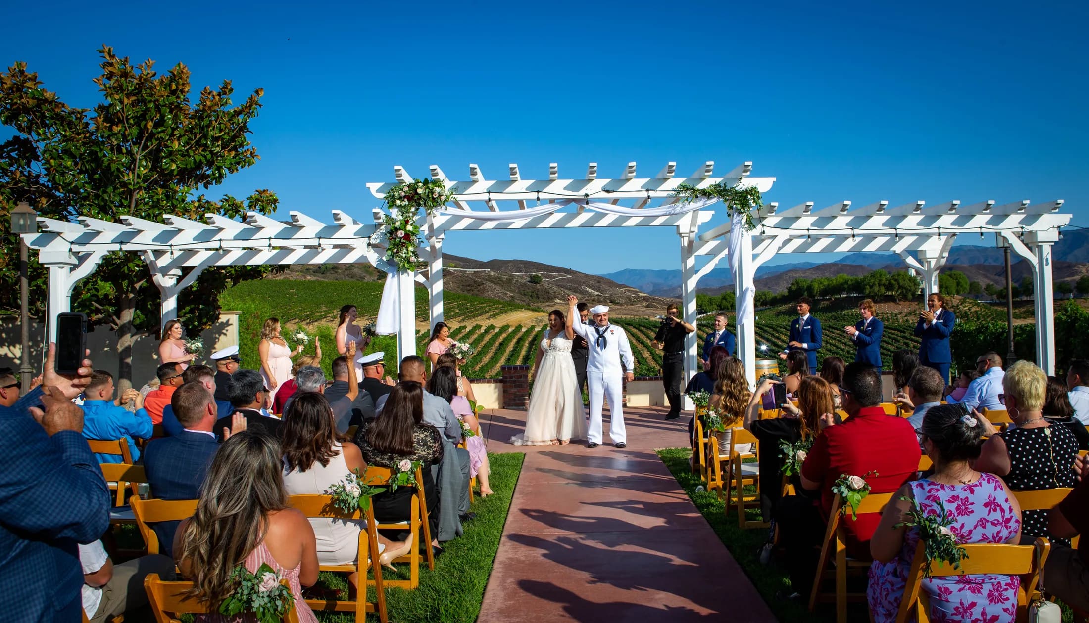 Deidriana and Gustavo celebrating after their outdoor wedding ceremony at Leoness Cellars
