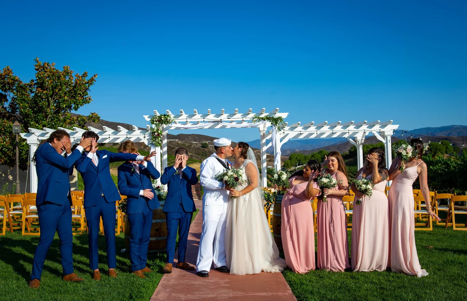Wedding party portrait beside the vineyard ceremony pergola