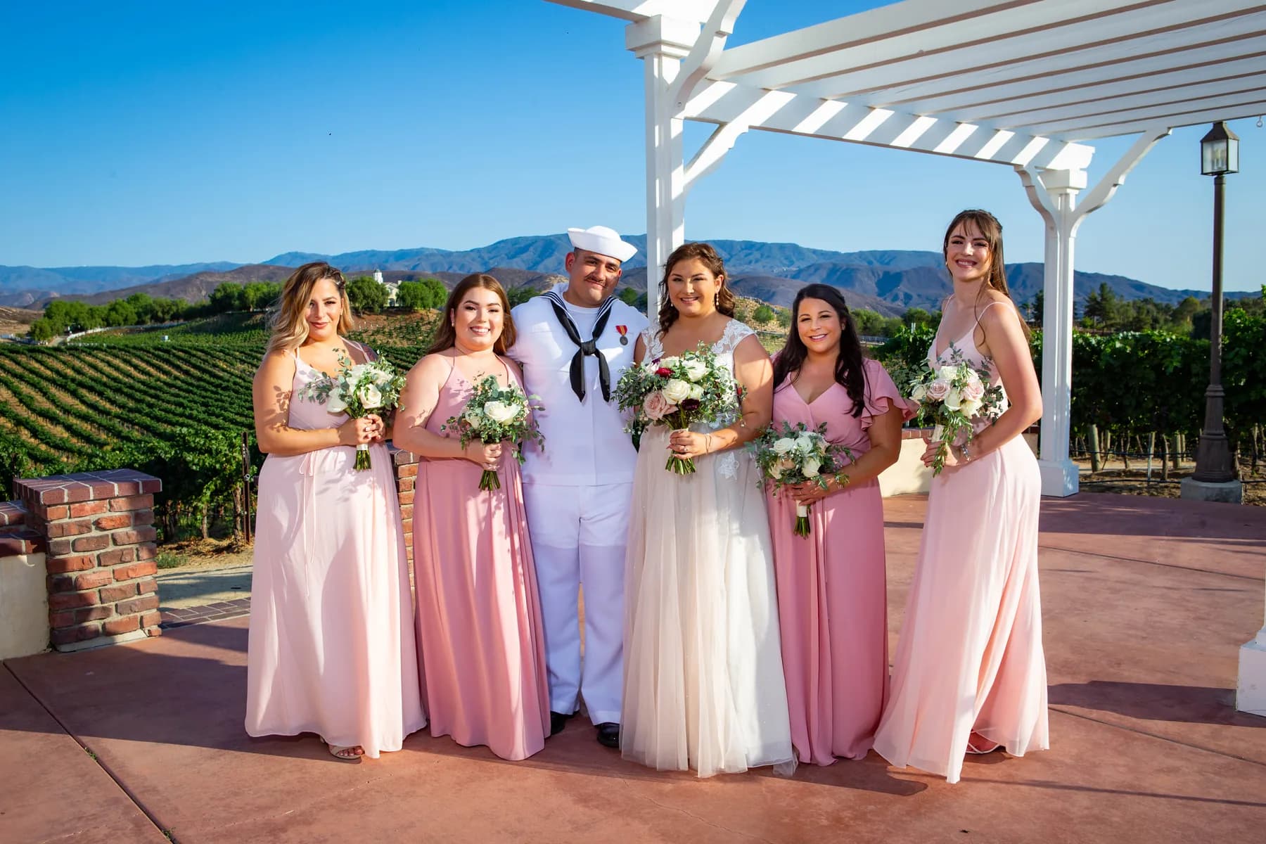 Gustavo with attendants beneath the white pergola