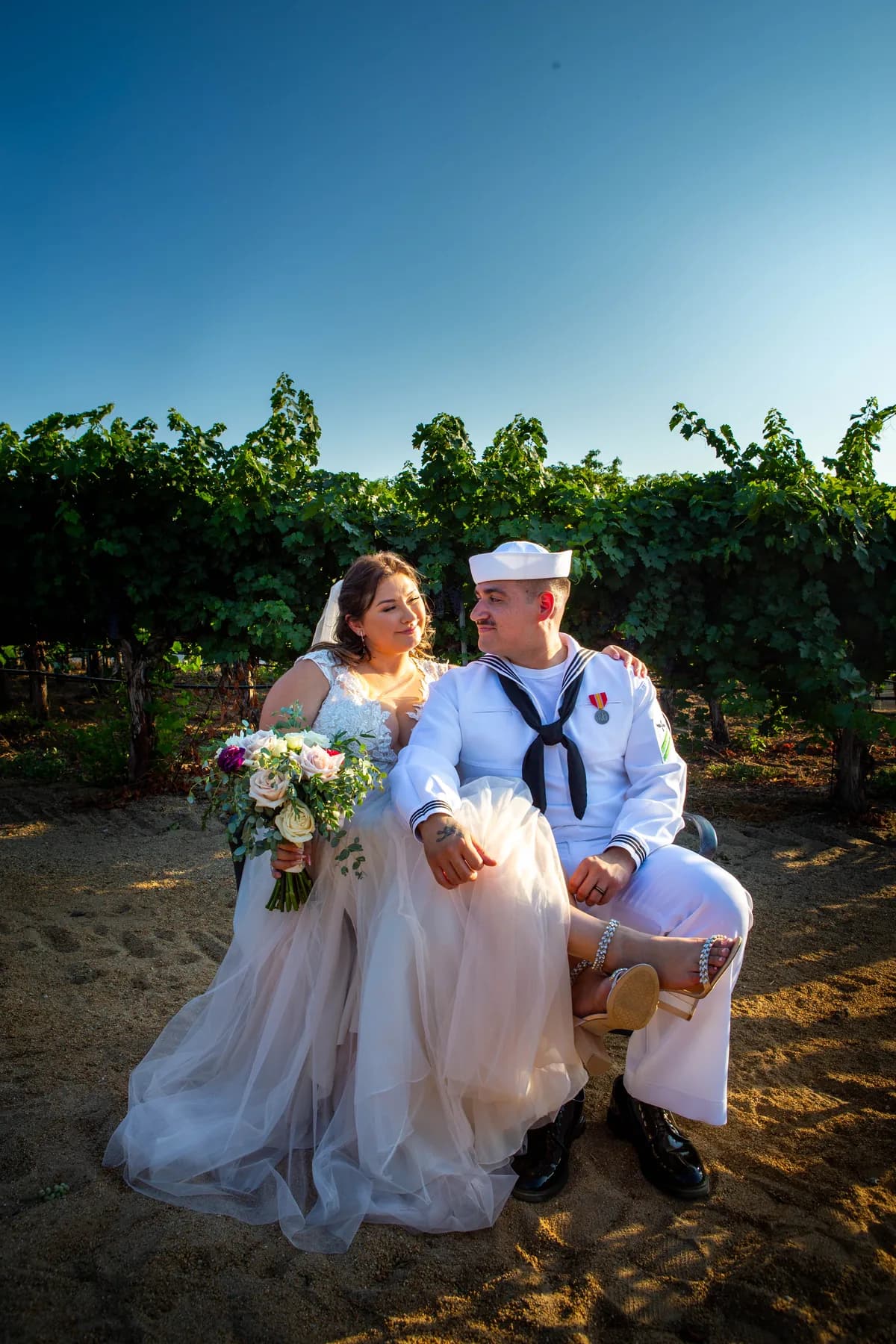 Seated portrait of Deidriana and Gustavo in the vineyard