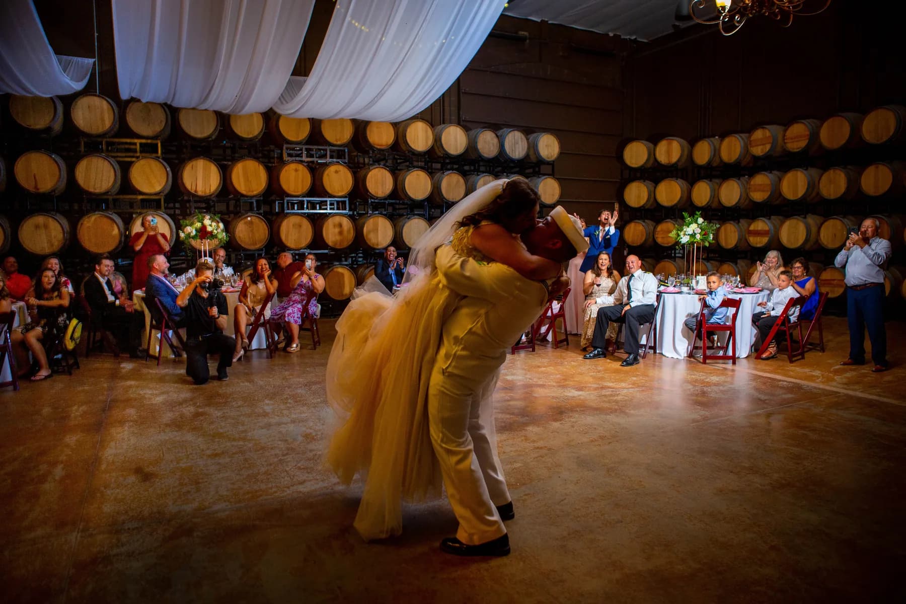 Deidriana and Gustavo moving across the dance floor during their Leoness Cellars barrel-room reception