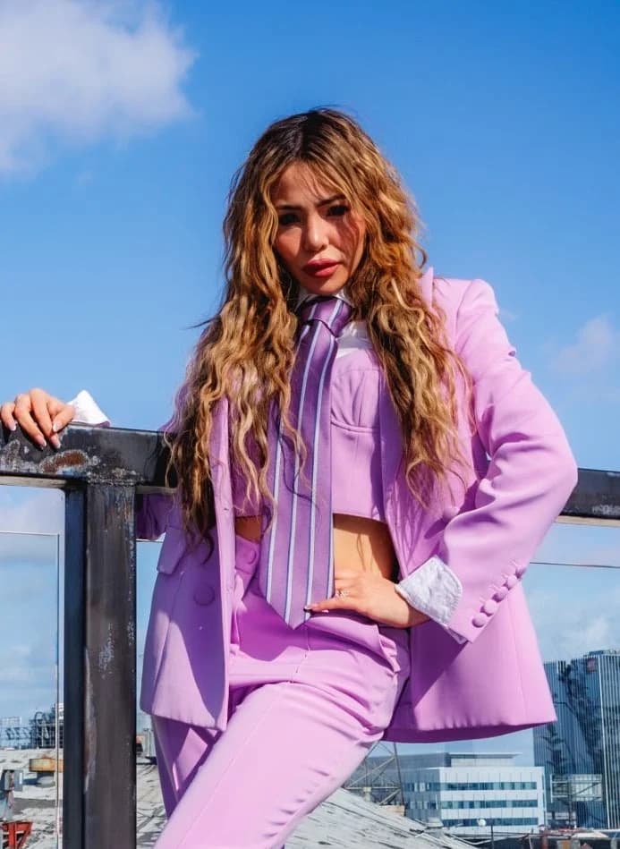 Lavender suit portrait with a hand on the hip
