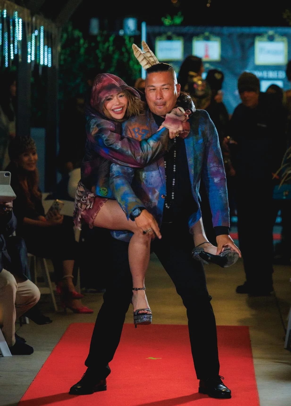Two models striking a playful runway pose