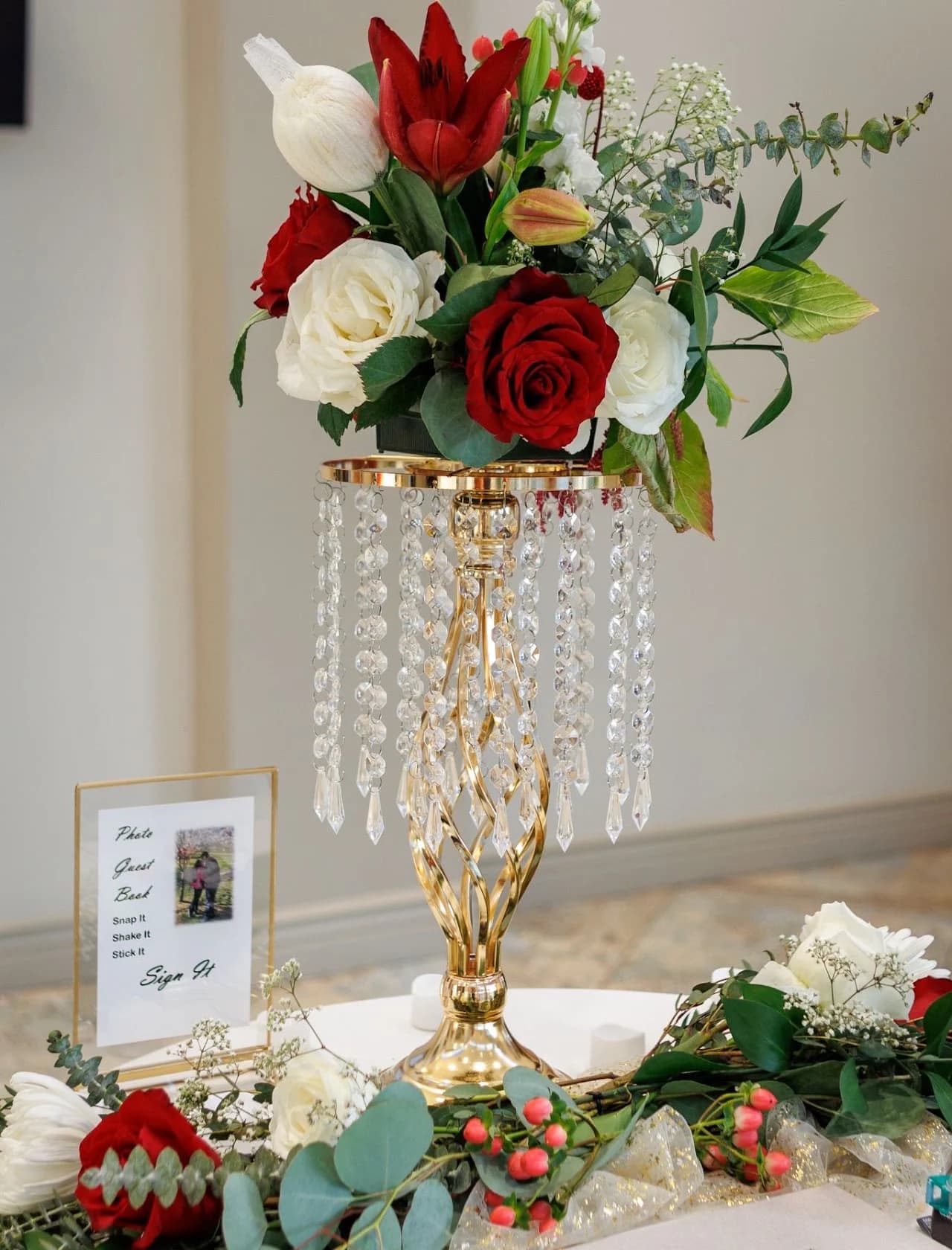 Tall floral centerpiece with red and white flowers