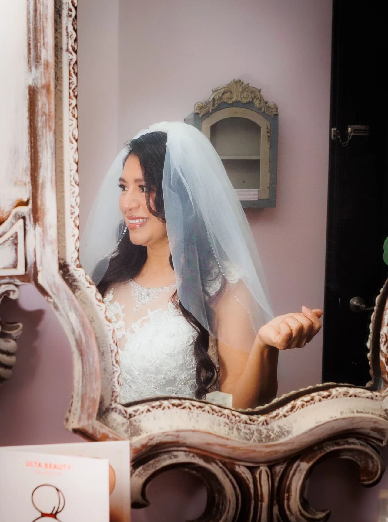 Veiled woman holding a mirror