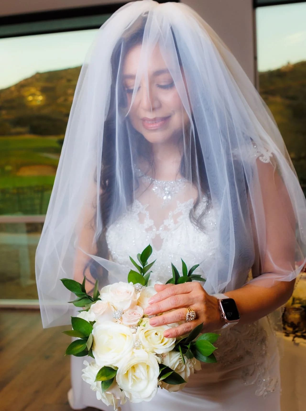 Portrait with a veil and red-and-white bouquet