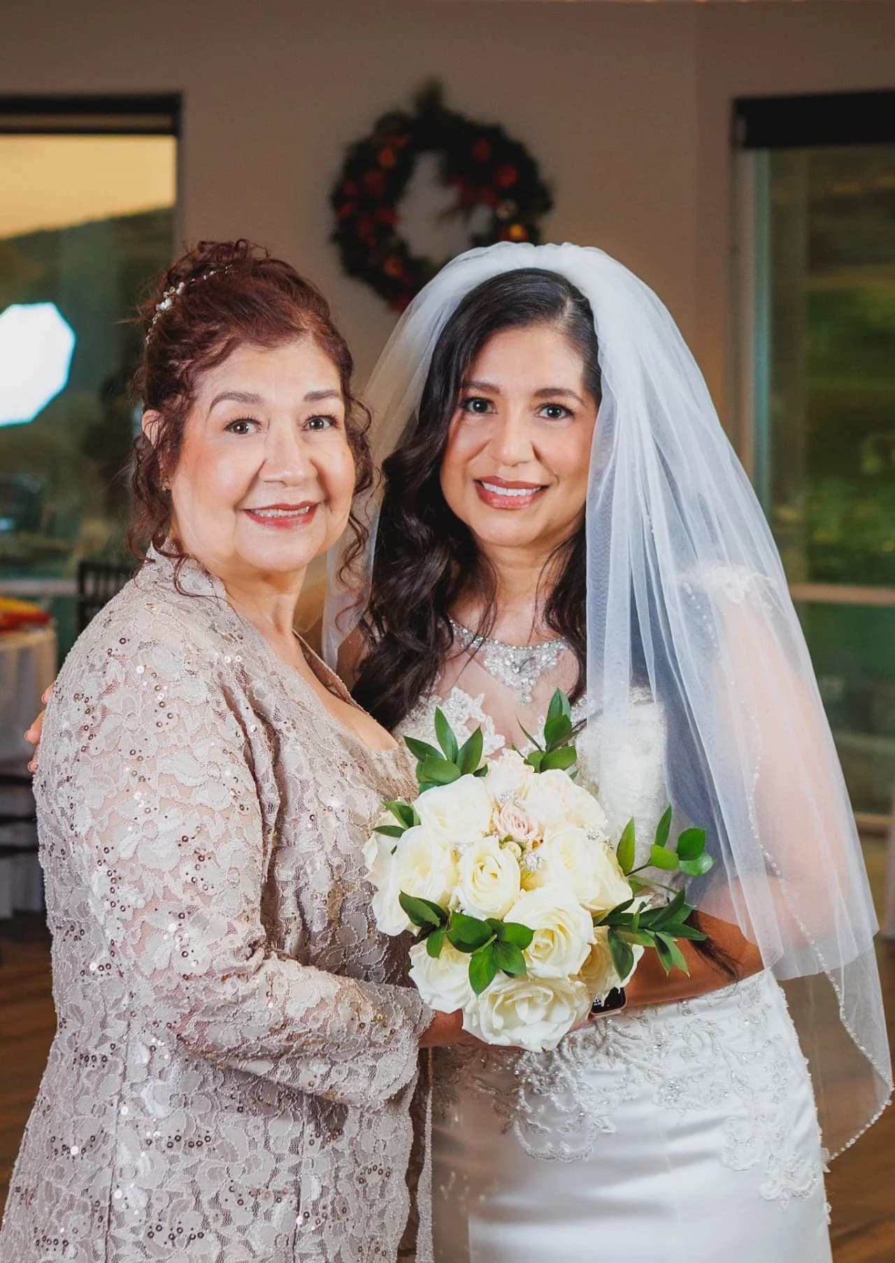 Two women embracing beside the bouquet