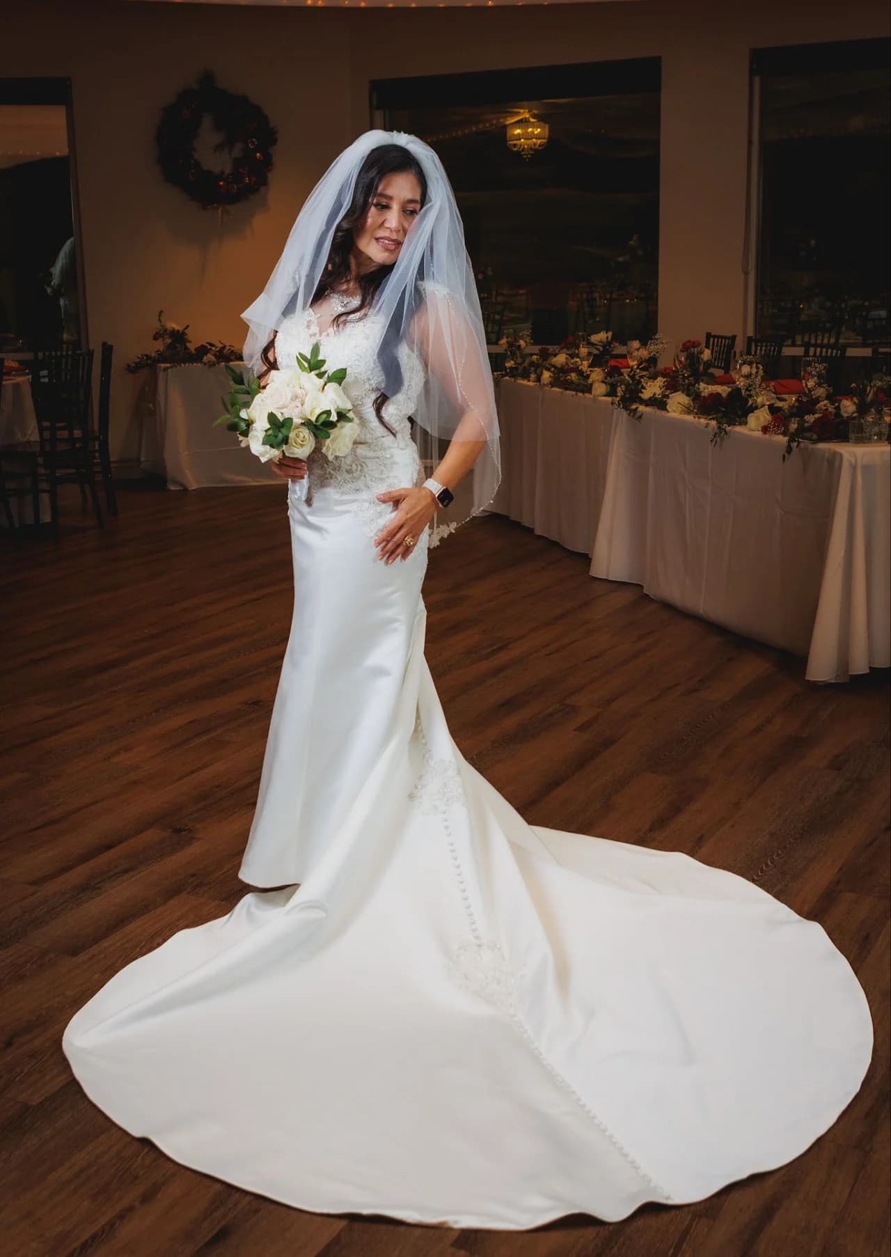 Full-length gown portrait beside a table