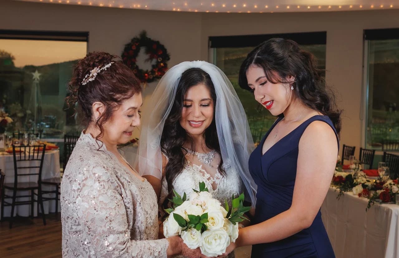 Three women gathered around a bouquet