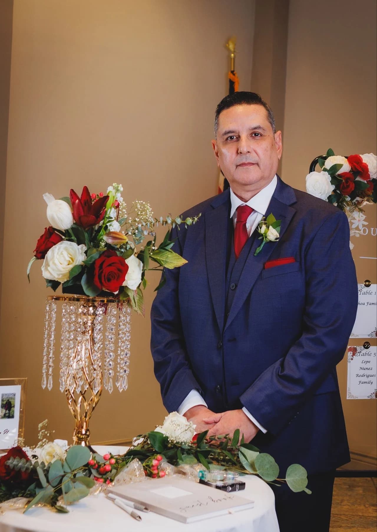 Man standing beside a decorated table