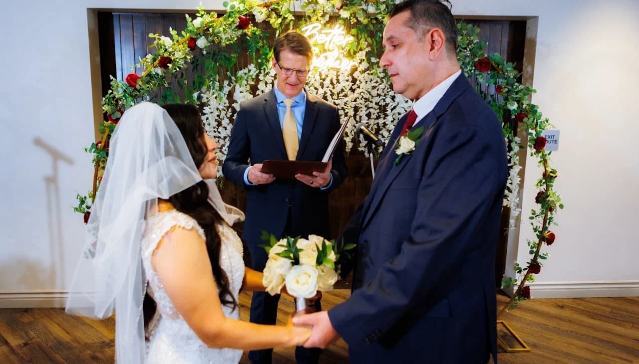 Couple facing each other beneath the flowers