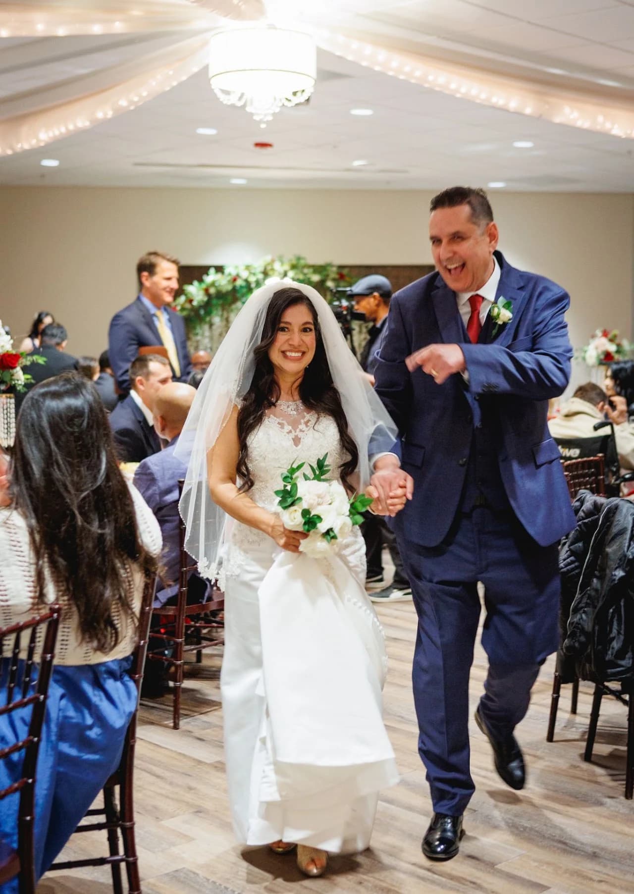 Couple raising their arms while walking together