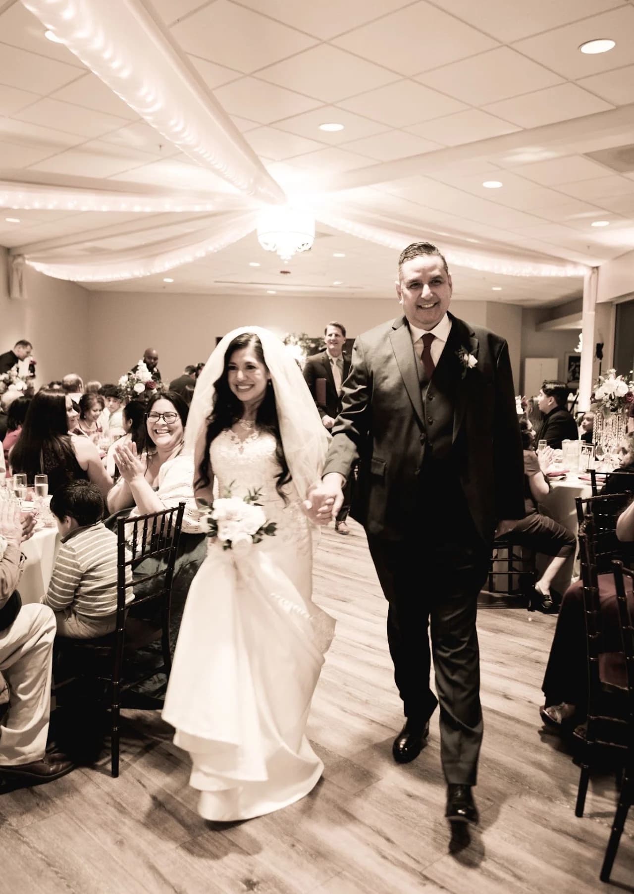 Black-and-white view of the couple entering the celebration