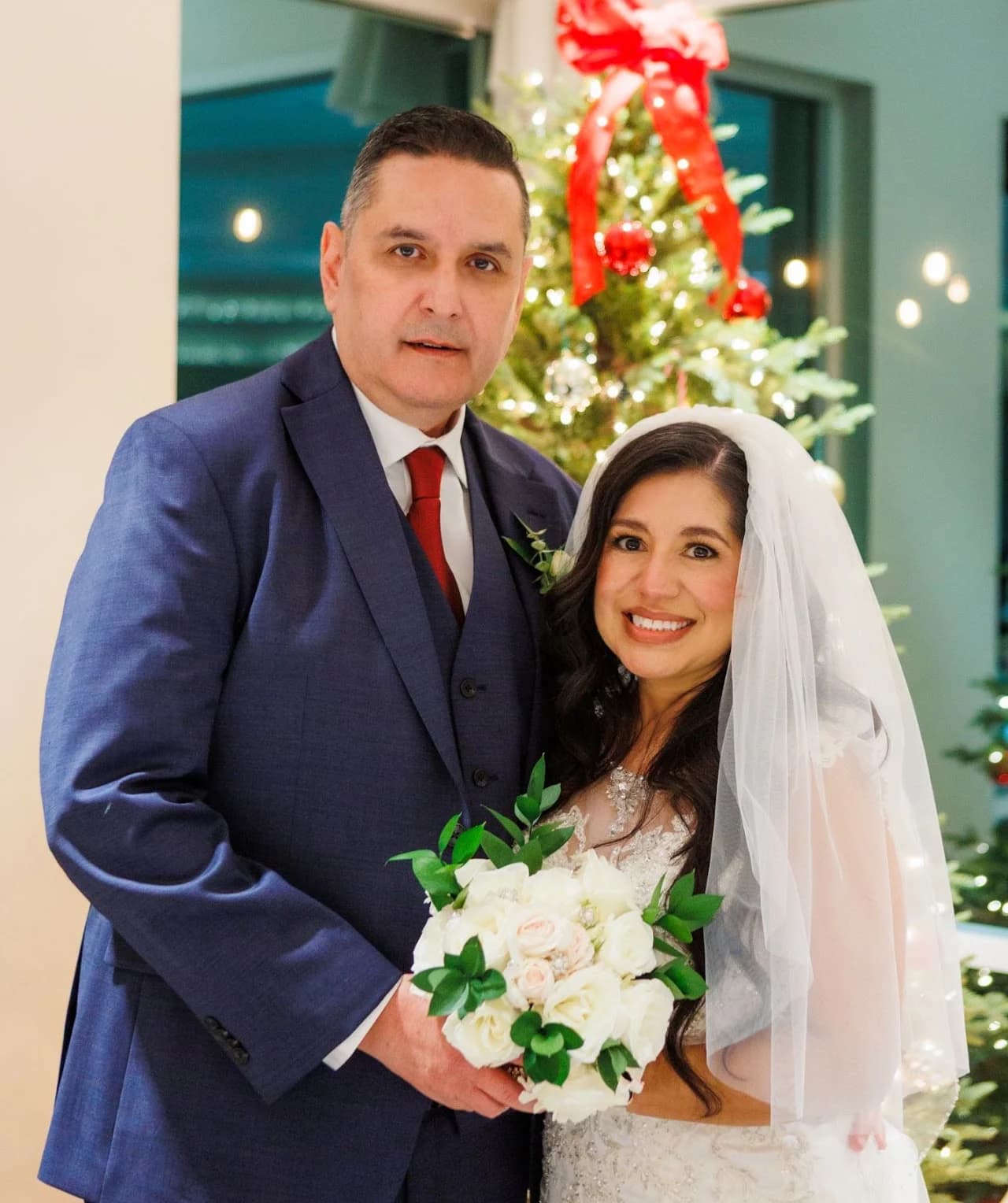 Couple holding a red-and-white bouquet