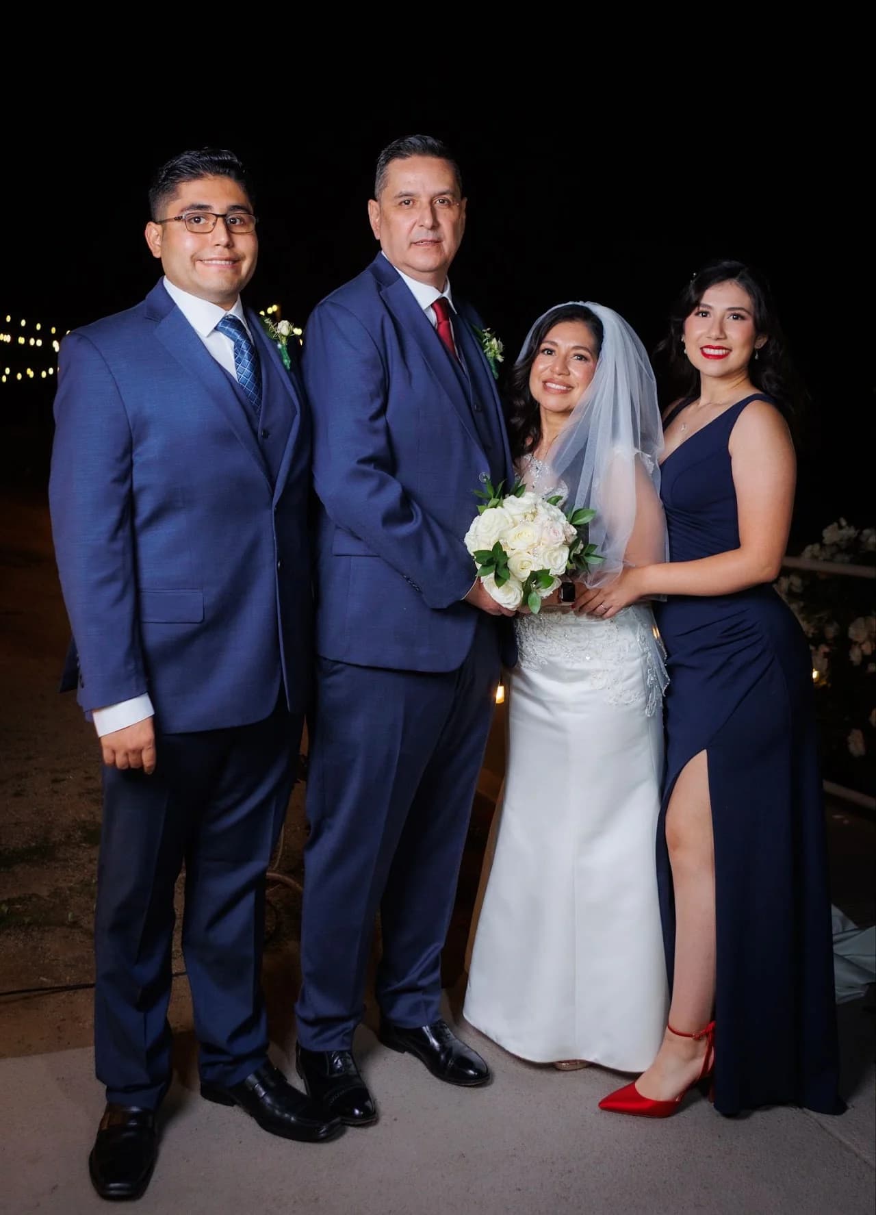 Four-person portrait beneath evening lights