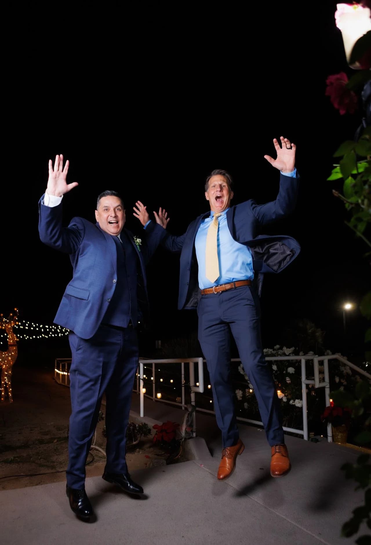 Group raising their arms for a playful evening portrait