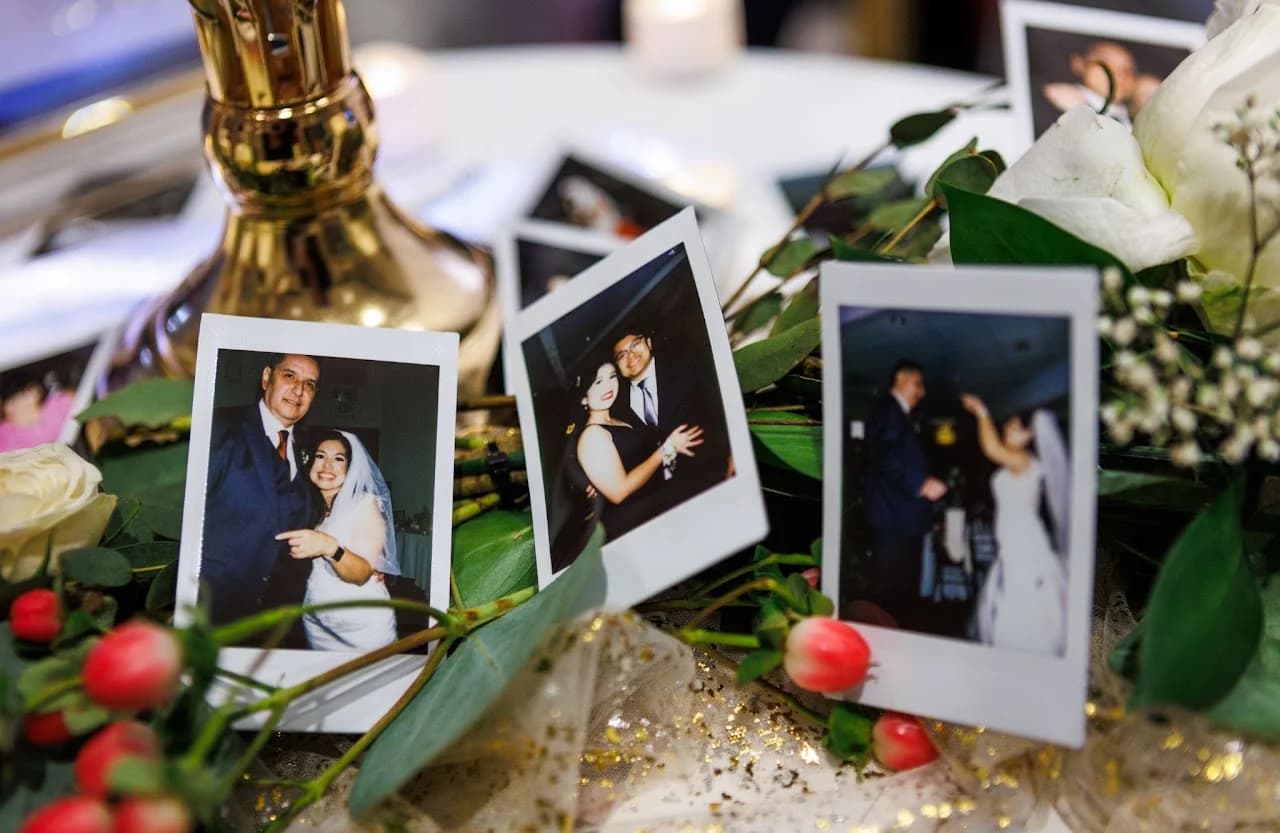 Framed photographs arranged among reception flowers