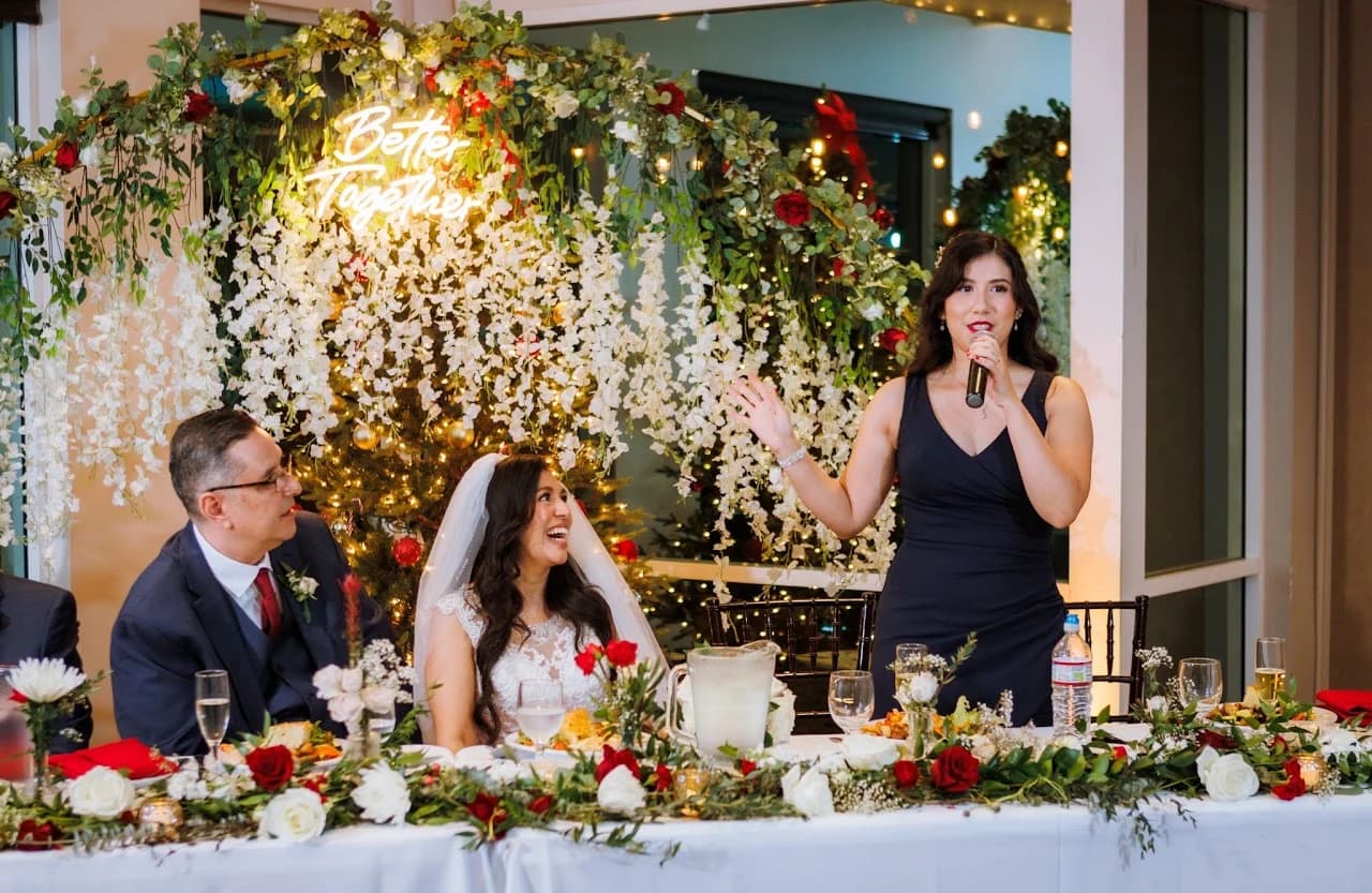 Guests and couple gathered at the decorated table