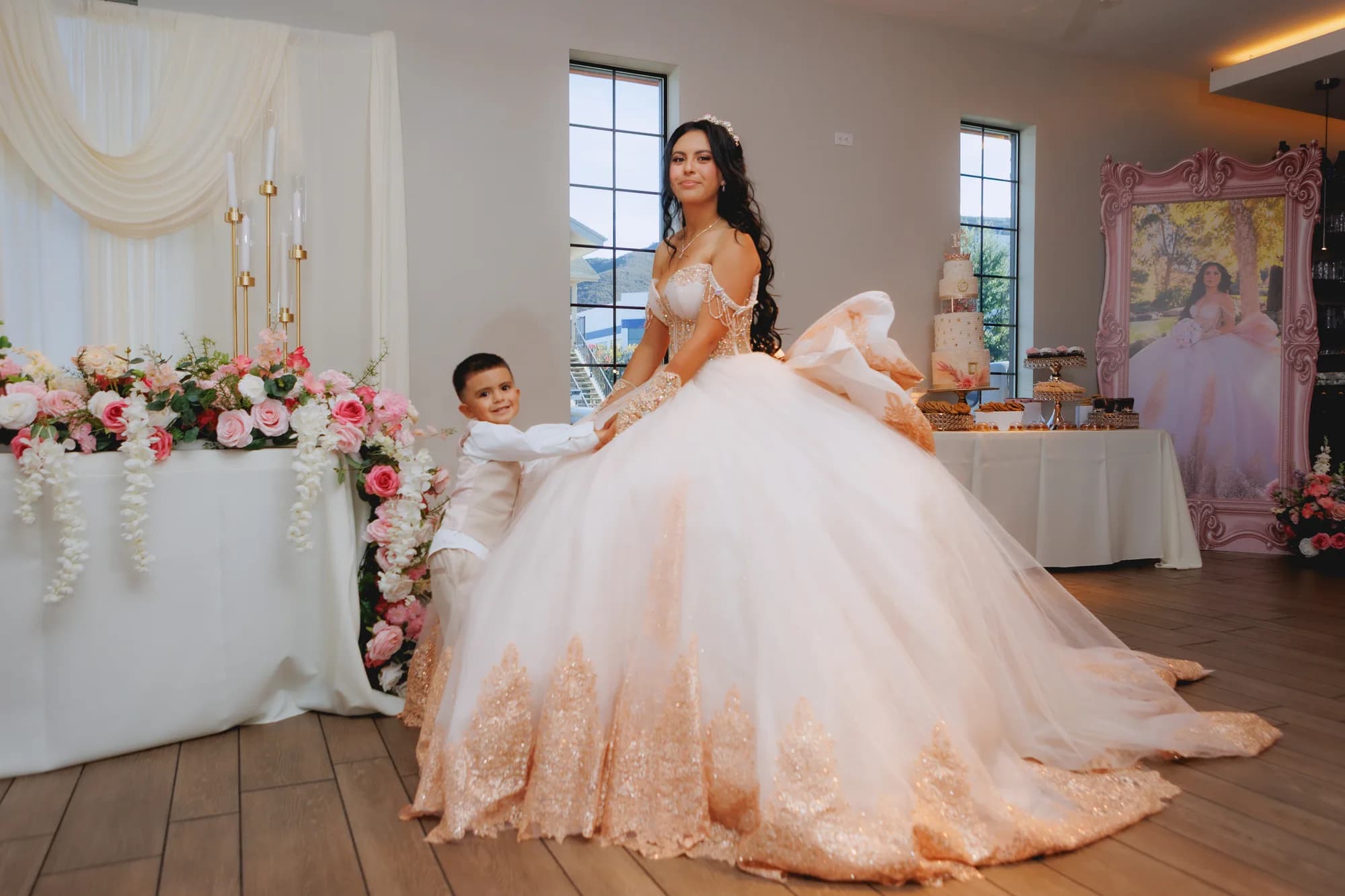 Isabella holding her skirt beside the floral reception table