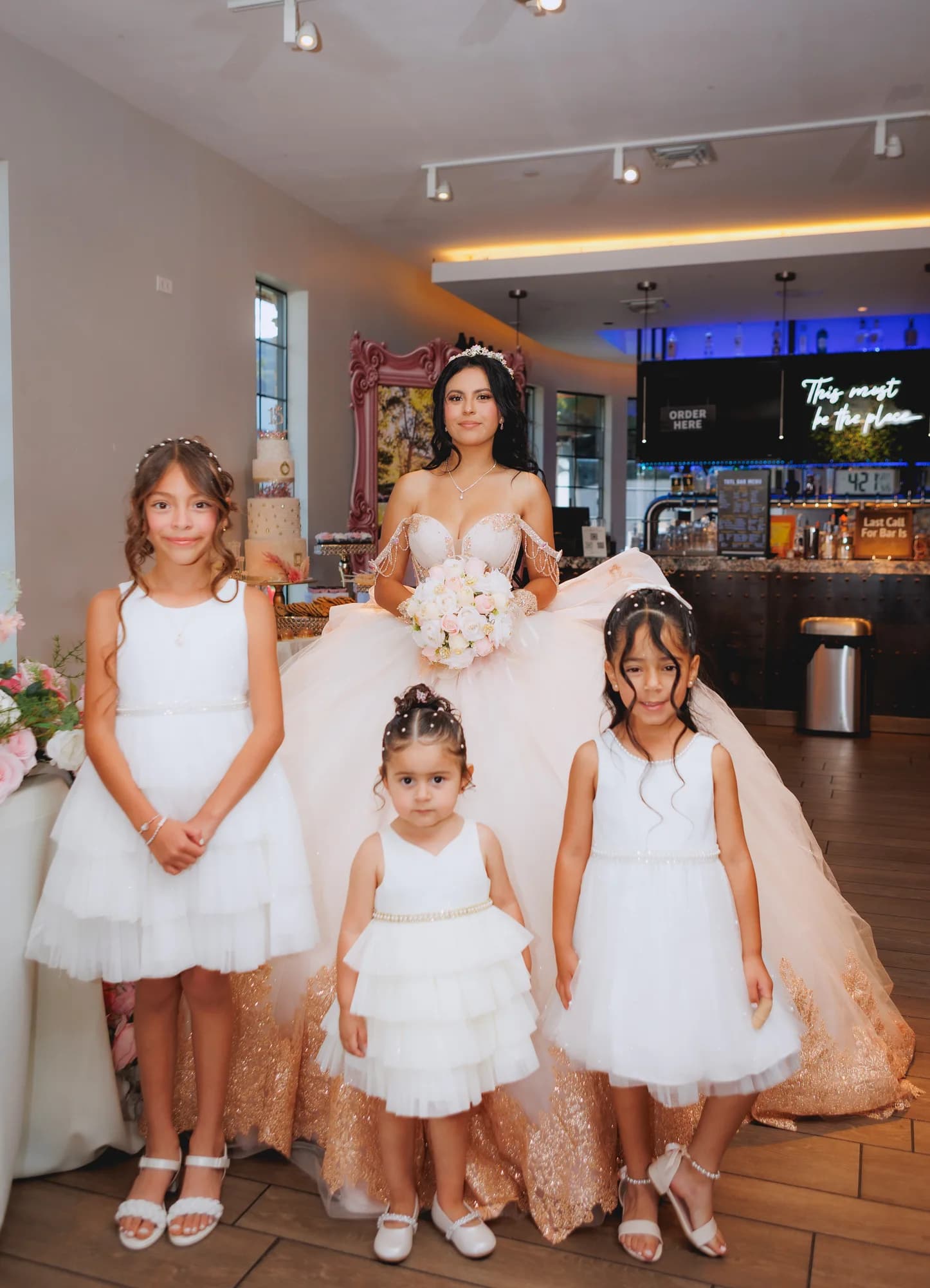 Isabella posing with young guests dressed in white