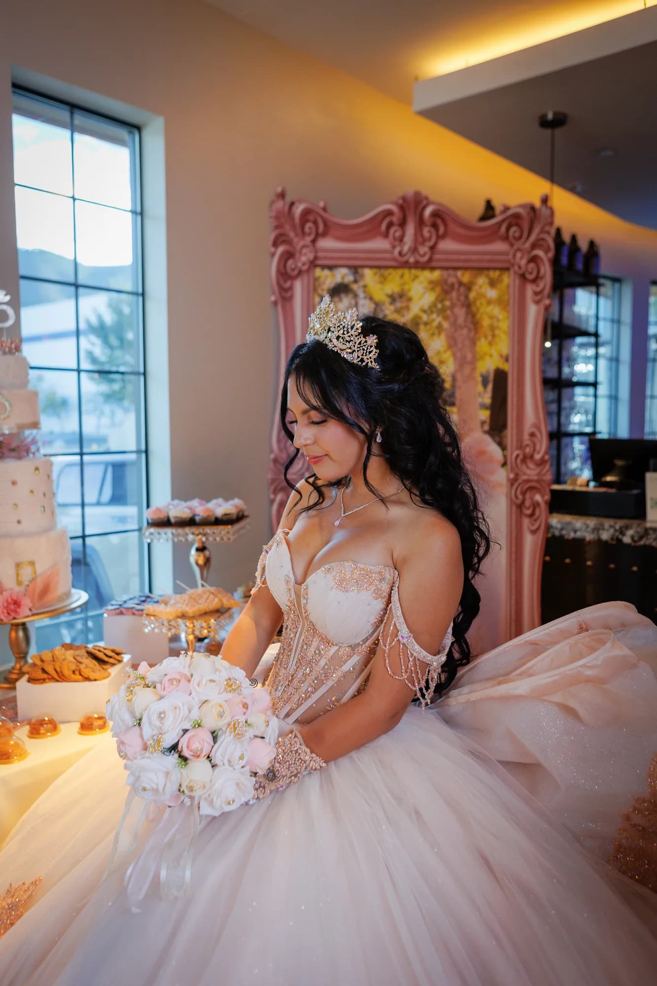 Isabella seated beside the window and ornate pink chair