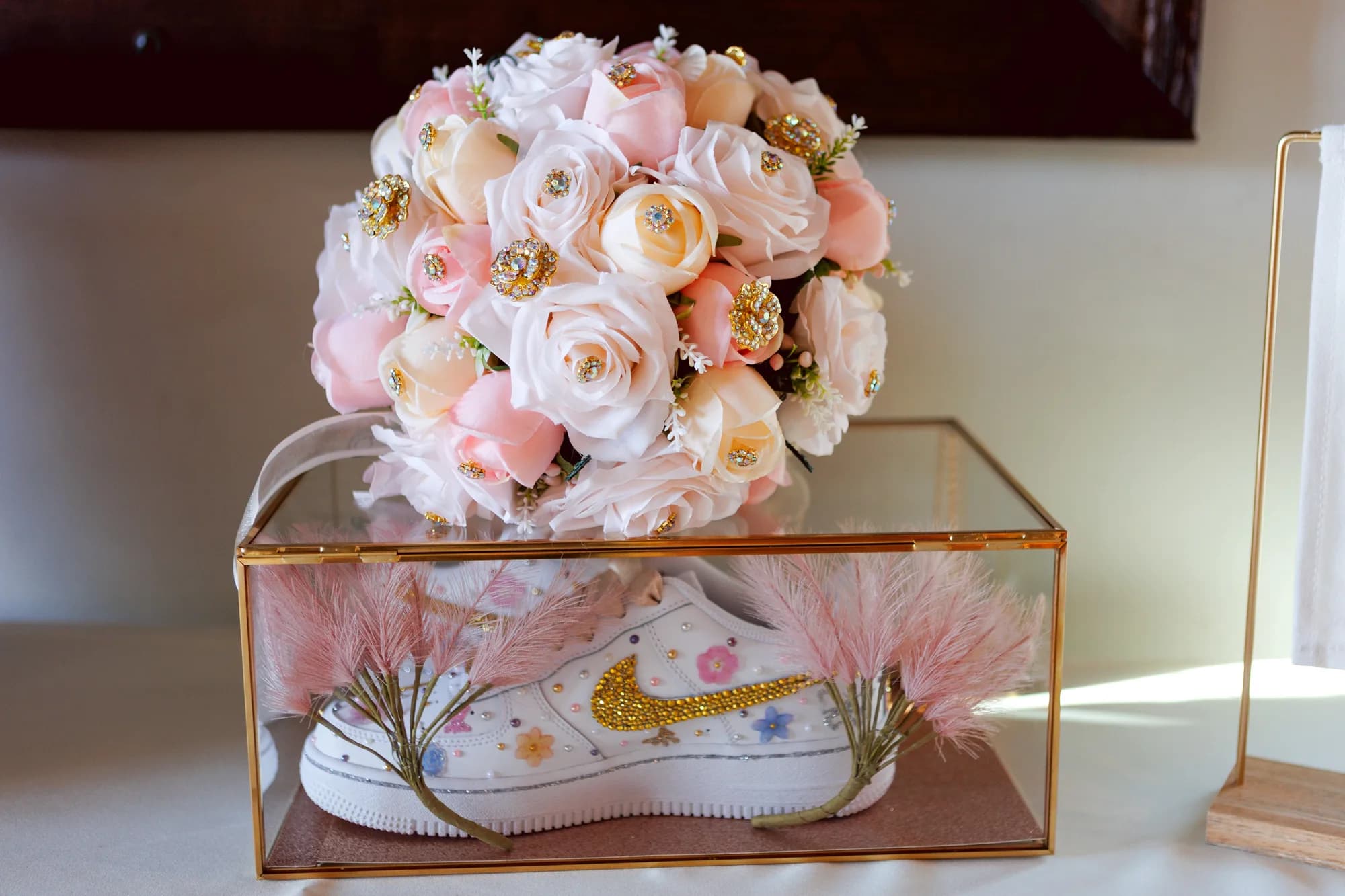 Pink and ivory bouquet displayed above a decorative keepsake box
