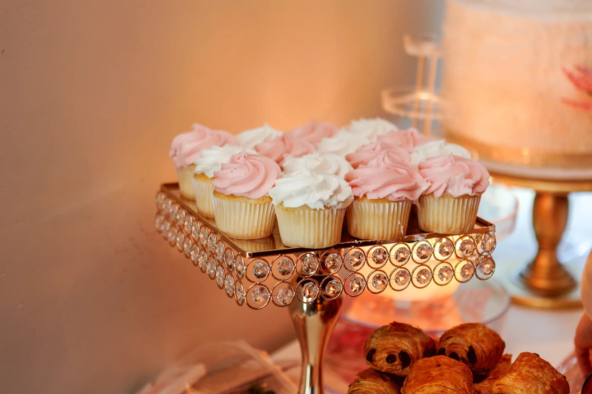 Pink cupcakes on an ornate dessert stand