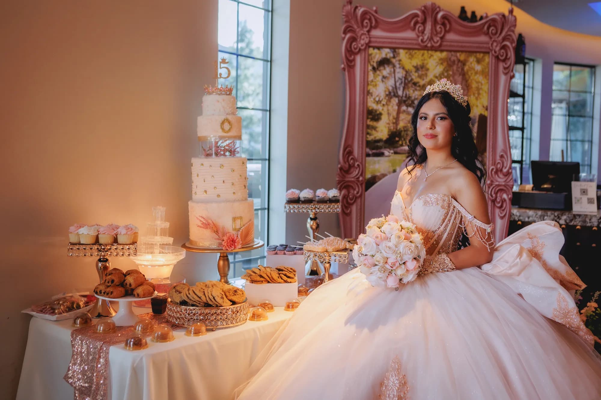 Isabella seated beside the cake and pink chair