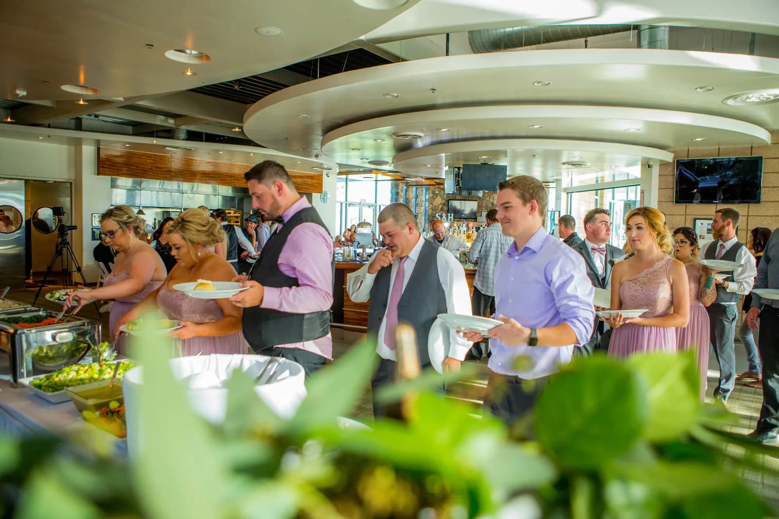 Guests moving through the buffet inside the reception space
